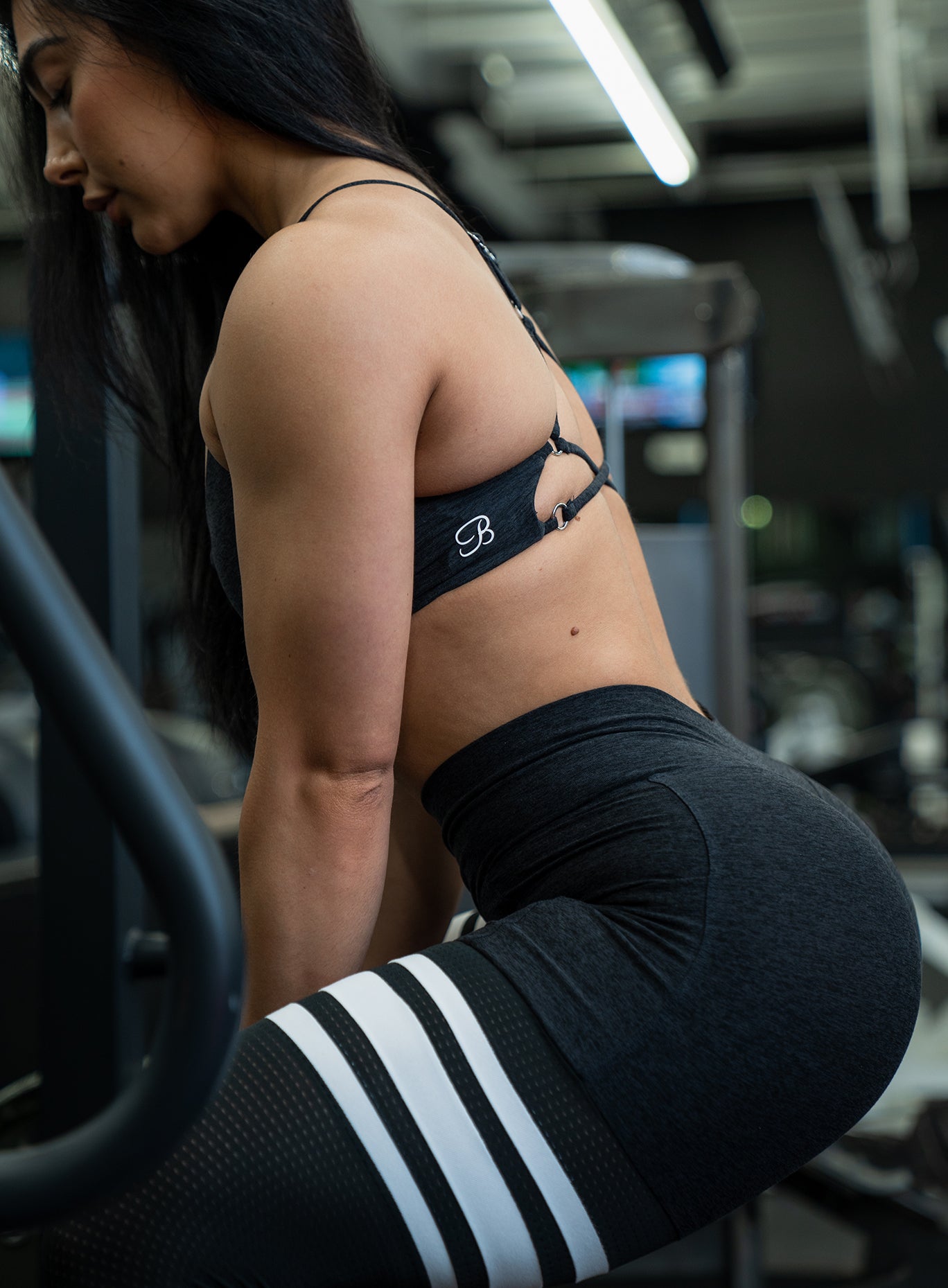 Girl working out in a gym wearing the Heathered Black Contour Thigh Highs