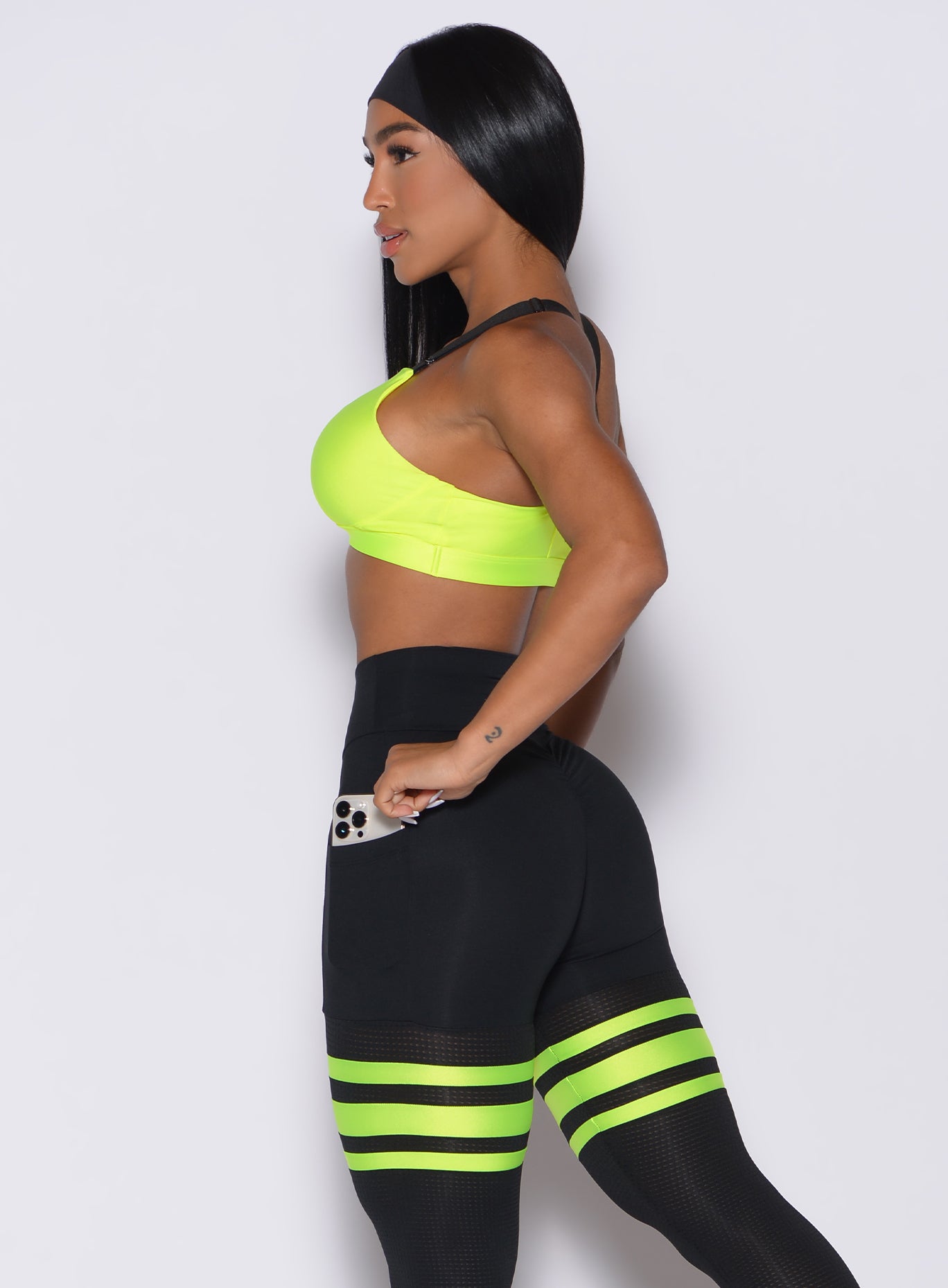 Neon yellow Glow Sports Bra with adjustable twist-back straps for a custom, sculpting gym fit.