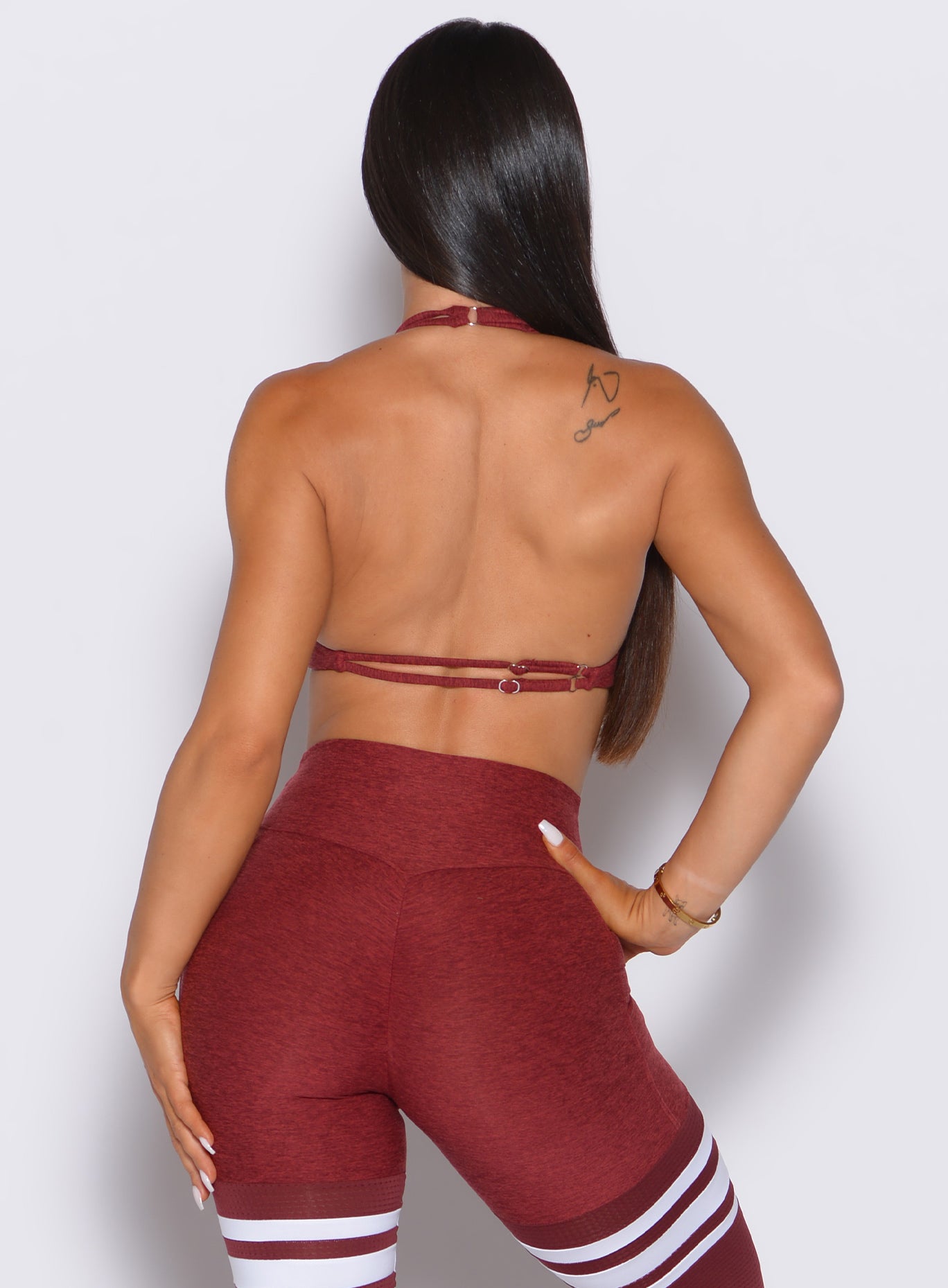 Backless rouge Dragonfly Bra with twist front neckline for a supportive, sculpting gym fit.