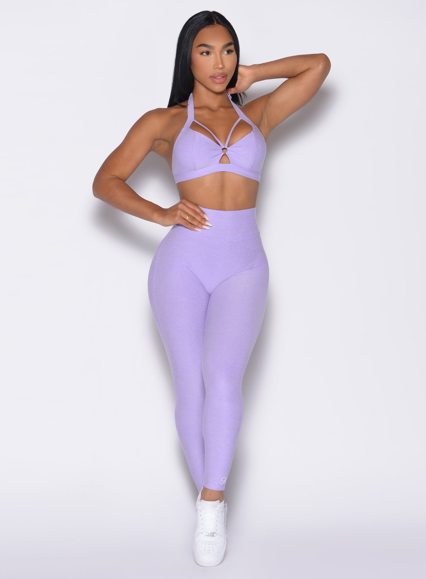 front profile view of a model looking to the left side wearing the Movement Leggings in Sugared Lilac color