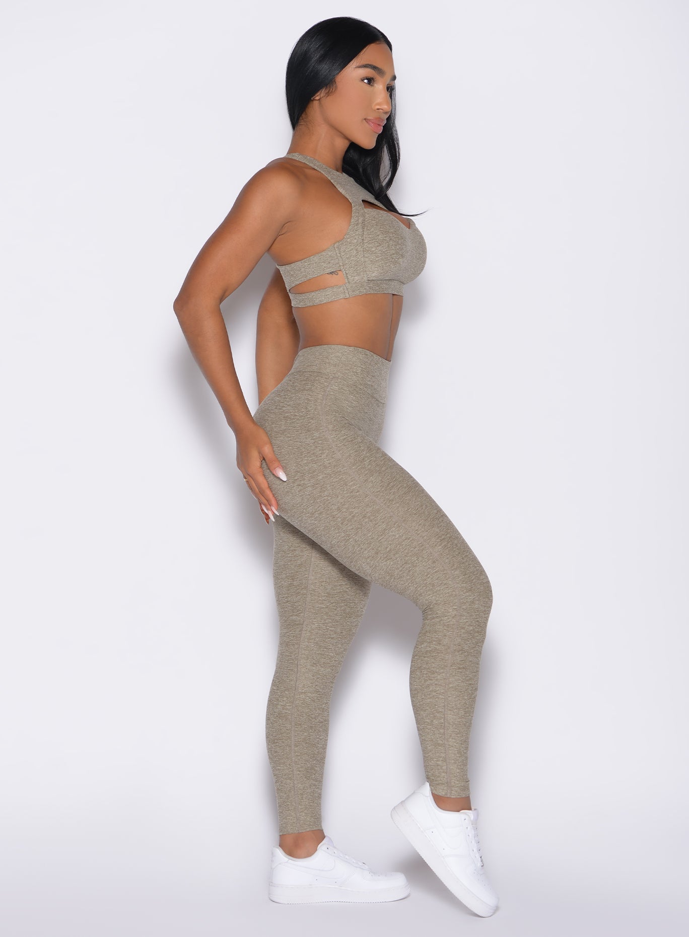 right side profile view of a model wearing the V Butt Lift Leggings in Toasted Sugar color