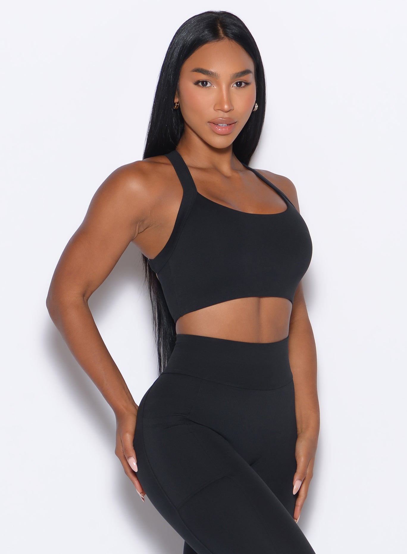 front profile picture of a model in our High Impact Bra in Black color and the matching leggings