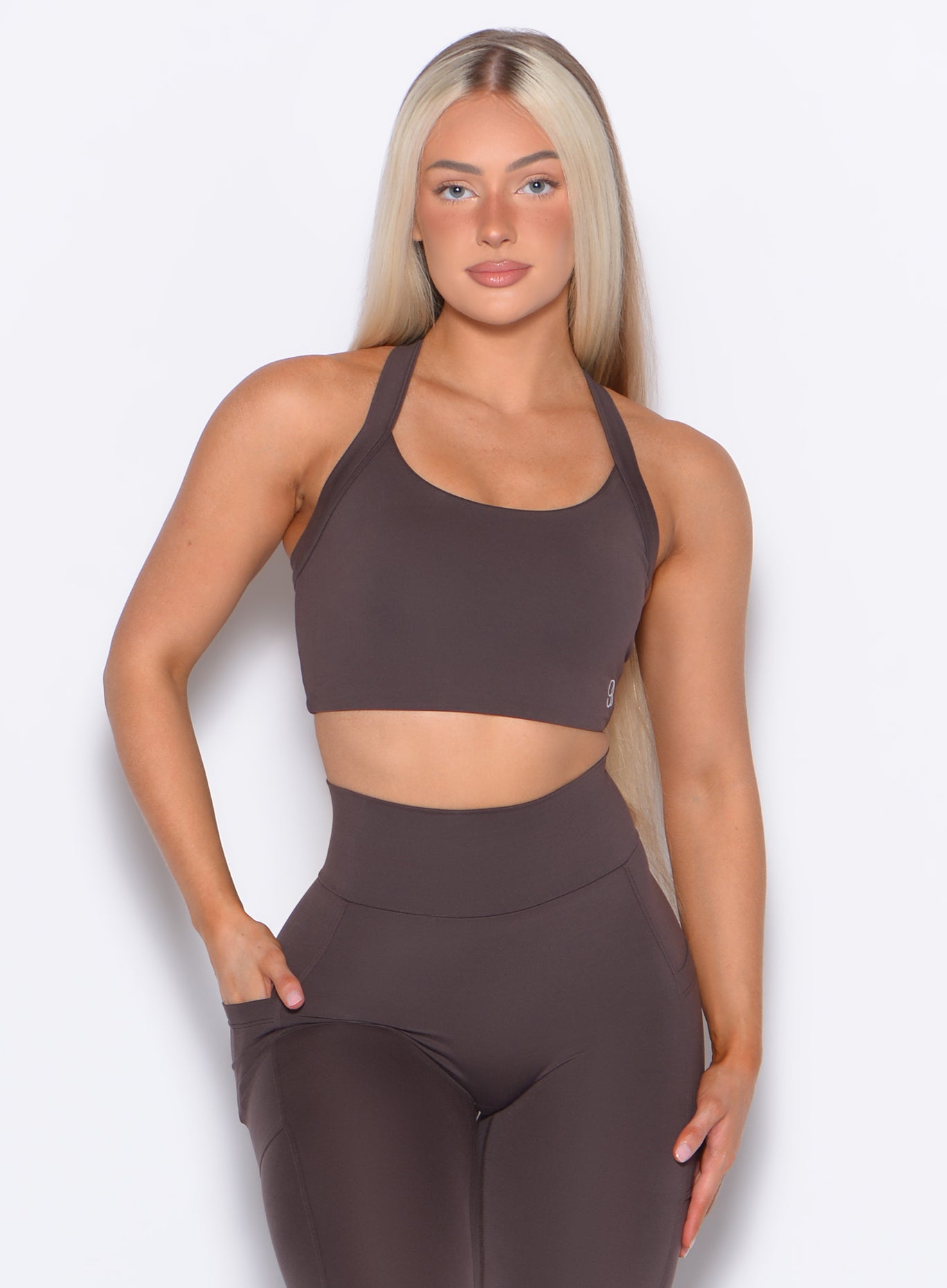 Model facing forward wearing our High Impact Bra in Seal Brown color and the matching leggings
