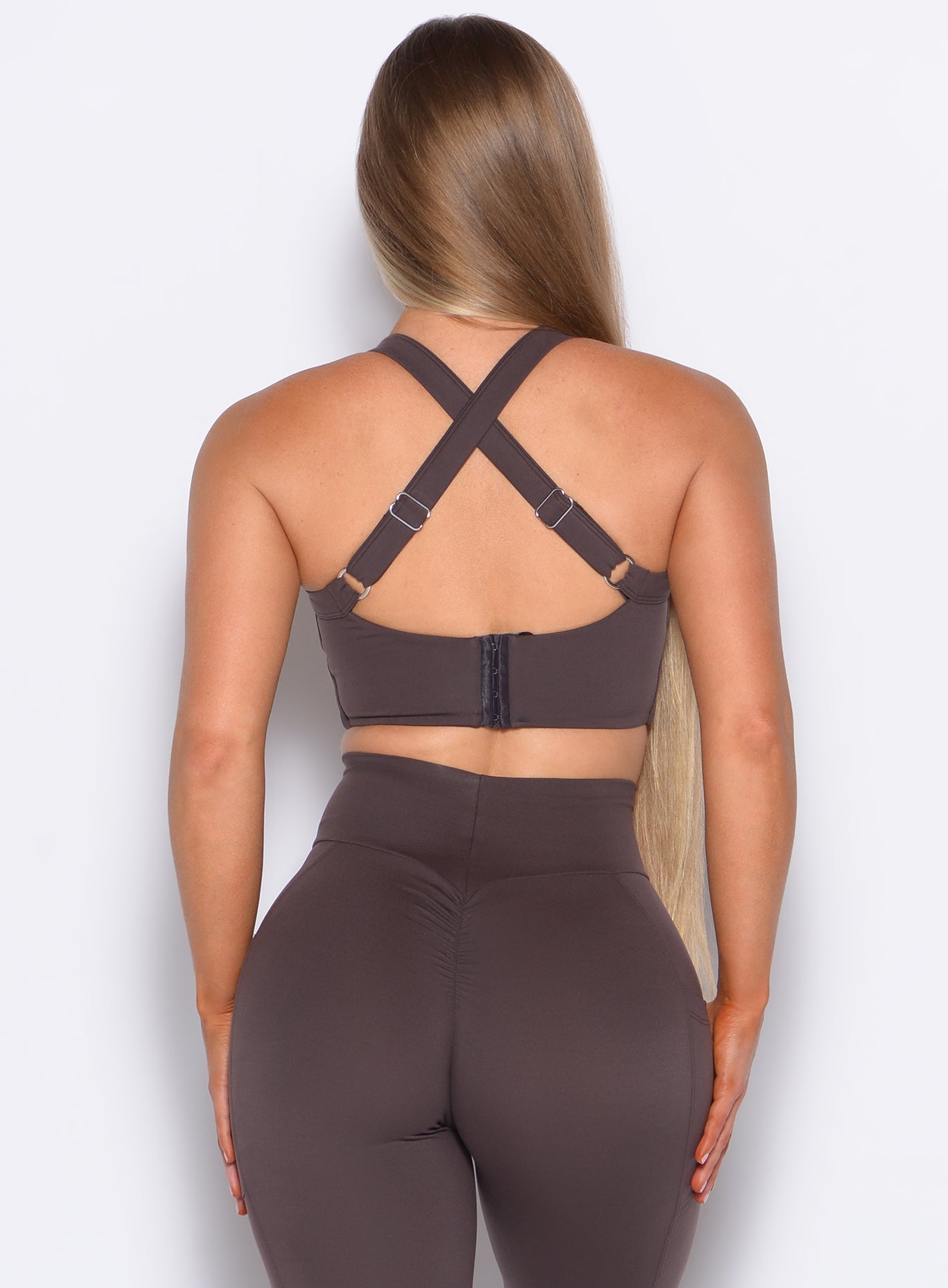 Back side close up view of model wearing the High Impact Bra in Seal Brown color and the matching leggings