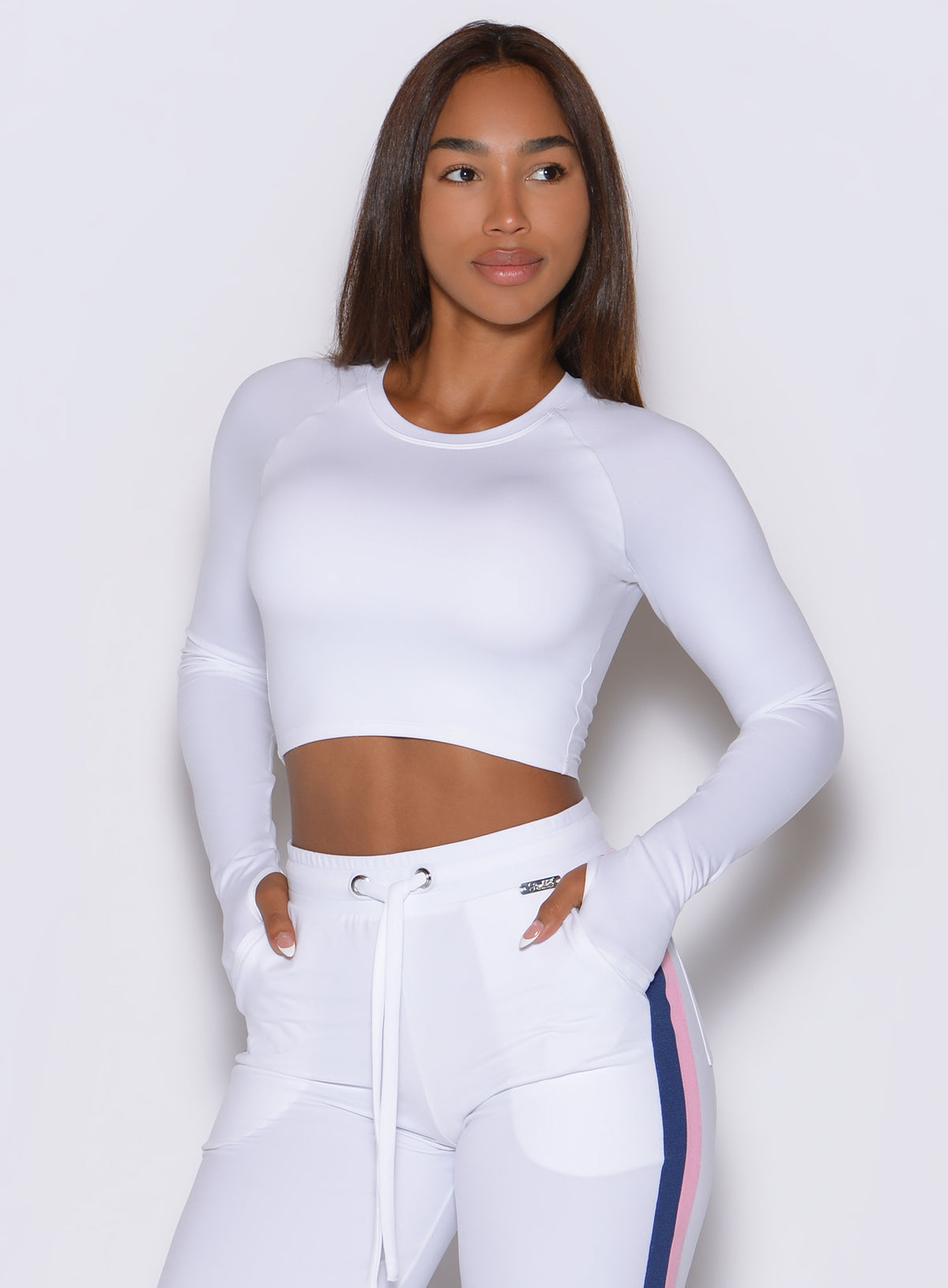 Bombshell Sportswear White Impact Pullover long sleeve crop top with thumbholes.