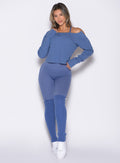 front profile view of a model wearing the Luxe Leg Warmers in blue chill color paired with the matching leggings and pullover
