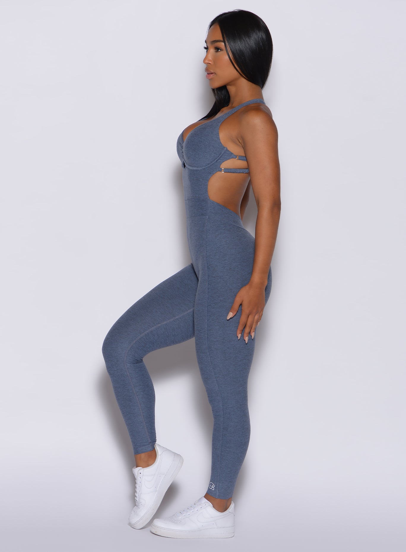 left side profile view of a model in our bombshell bodysuit in twilight color