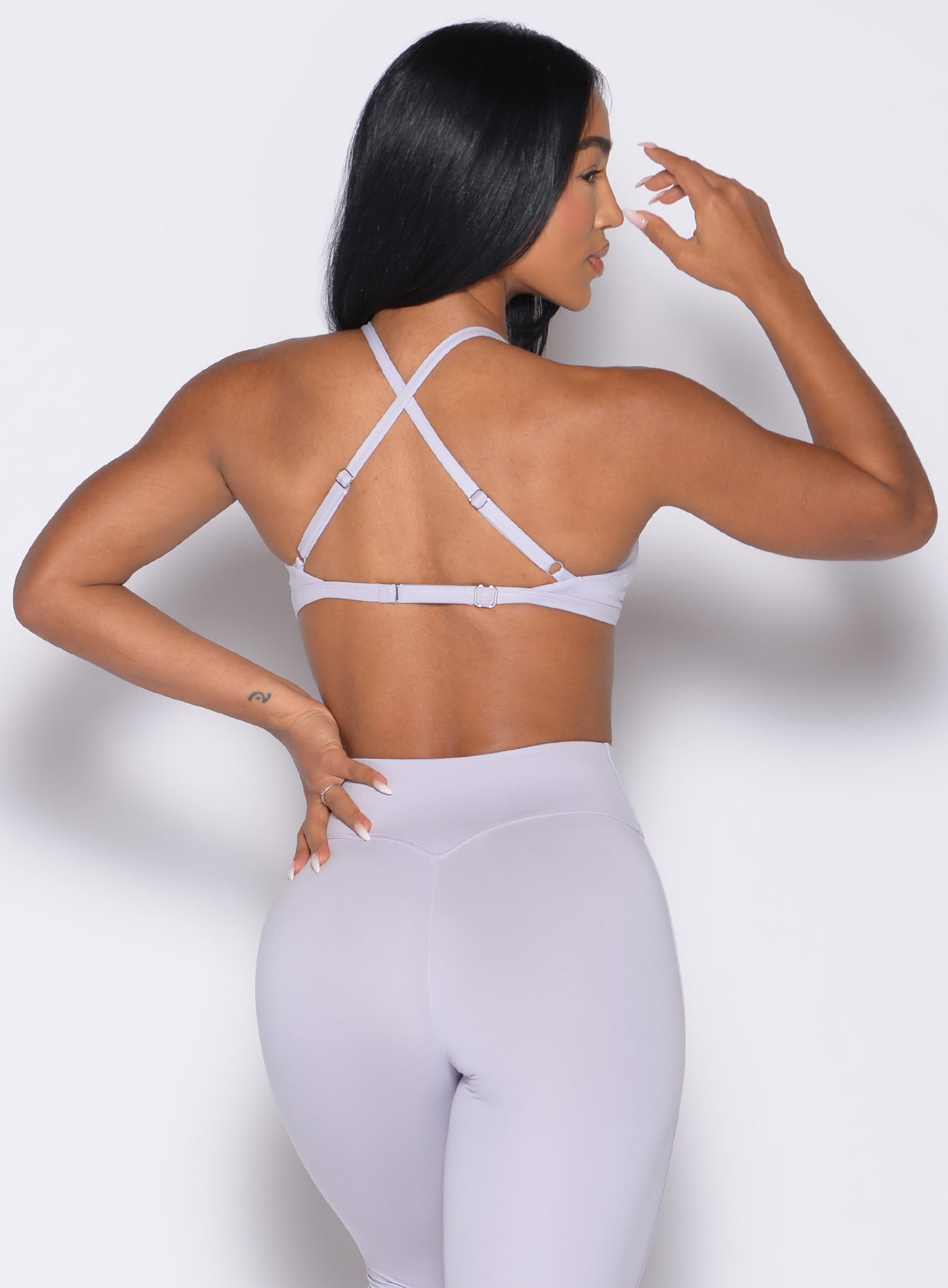 back profile view of a model wearing the Kini Bra in Galactic Lilac color