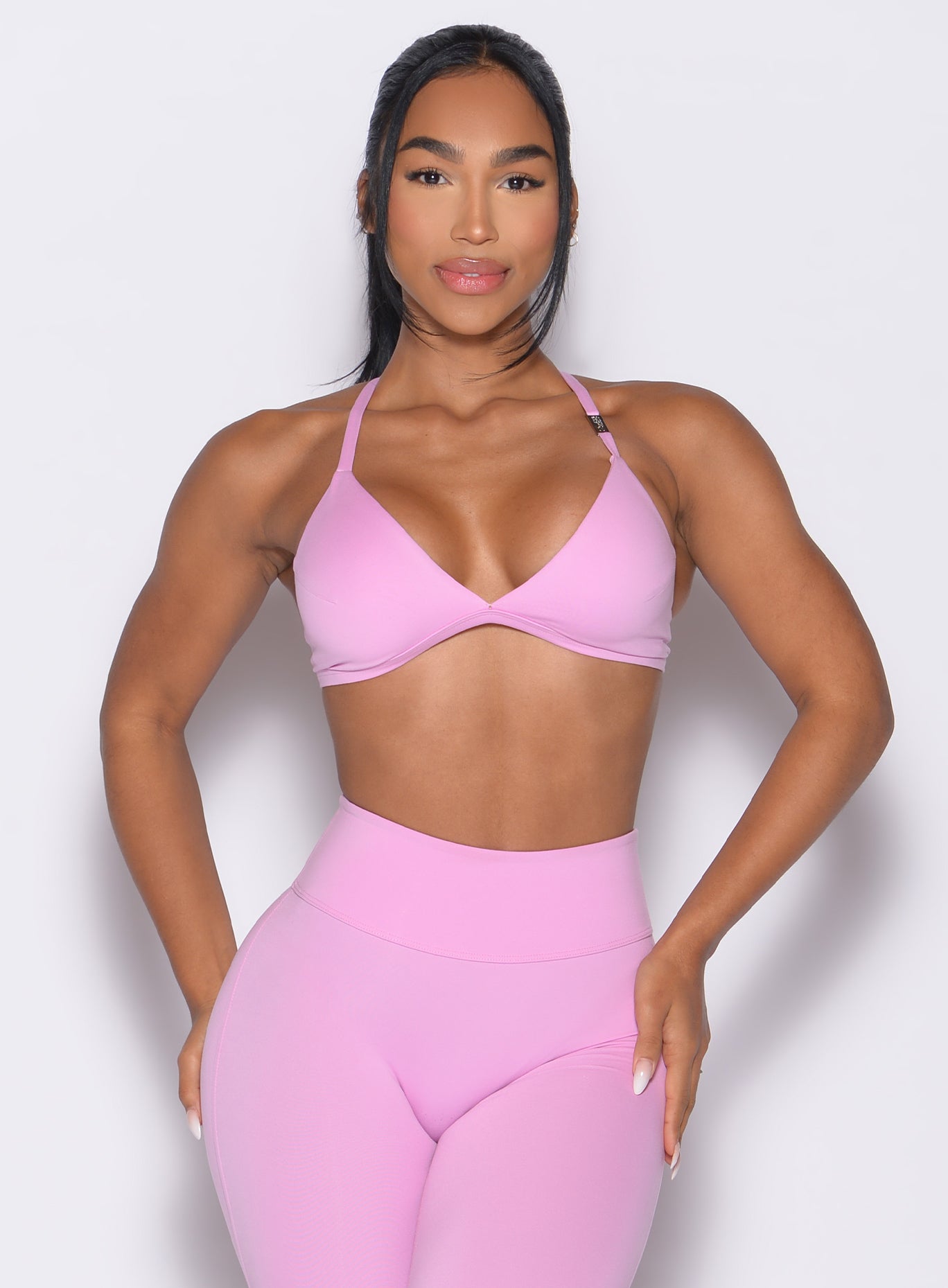 front profile view of a model with both hands on her thighs wearing the Kini Bra in Lilac Chiffon color