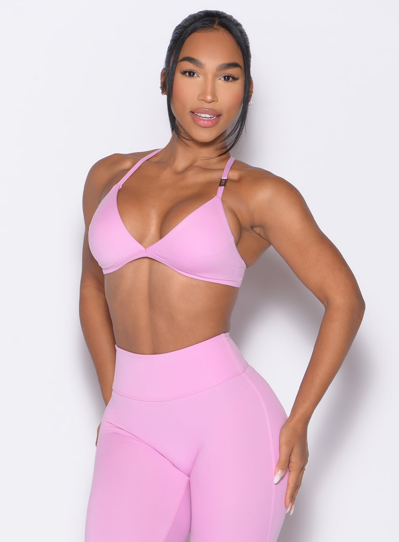 front profile view of a model wearing the Kini Bra in Lilac Chiffon color paired with the matching leggings
