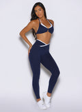 front right side profile view of a model wearing the Line Contour Leggings in navy color
