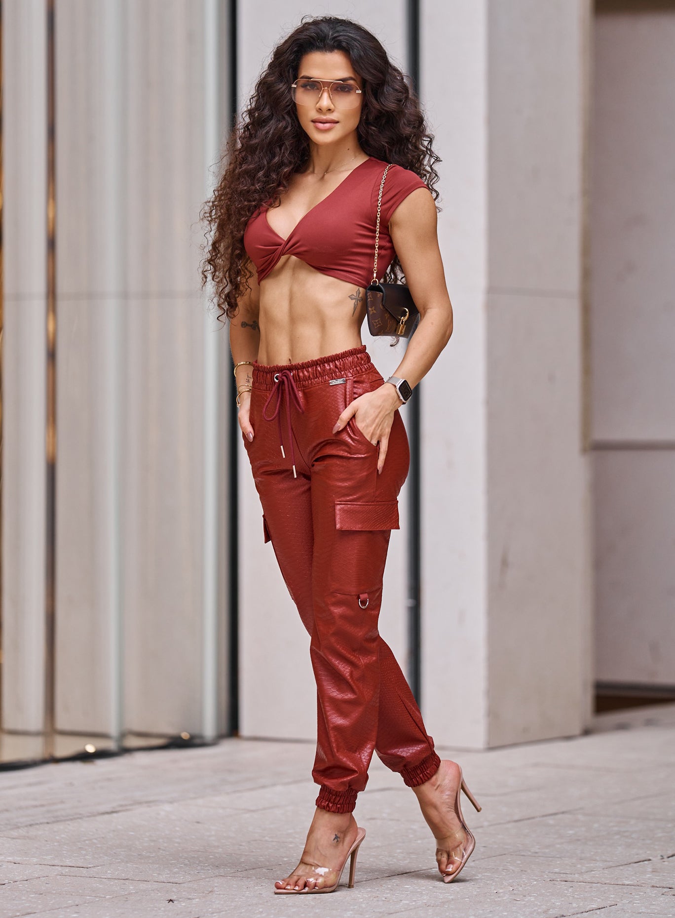 High-waisted Brick Red Liquid Cargos in sleek PU leather; edgy street style for day-to-night wear.