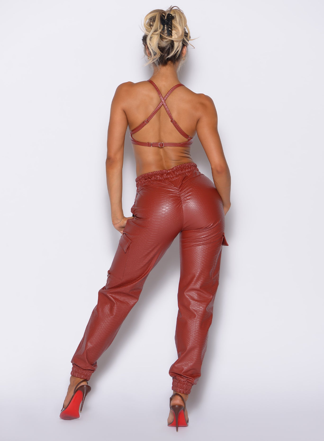 Sleek Brick Red Liquid Cargos in performance PU leather with a high-waist and sculpting scrunch.