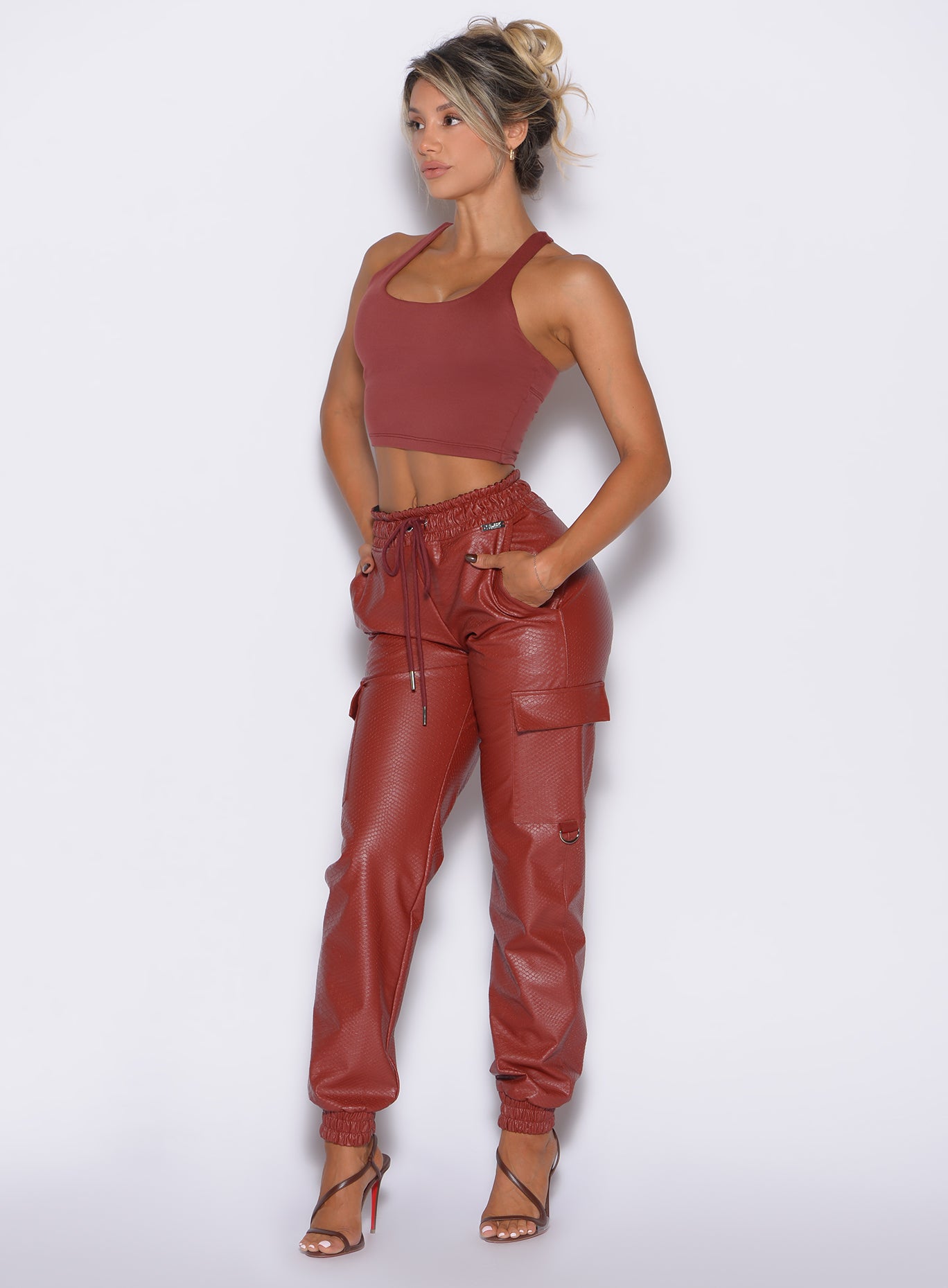 High-waisted Brick Red Liquid Cargos in sleek PU leather with side pockets for day-to-night style.