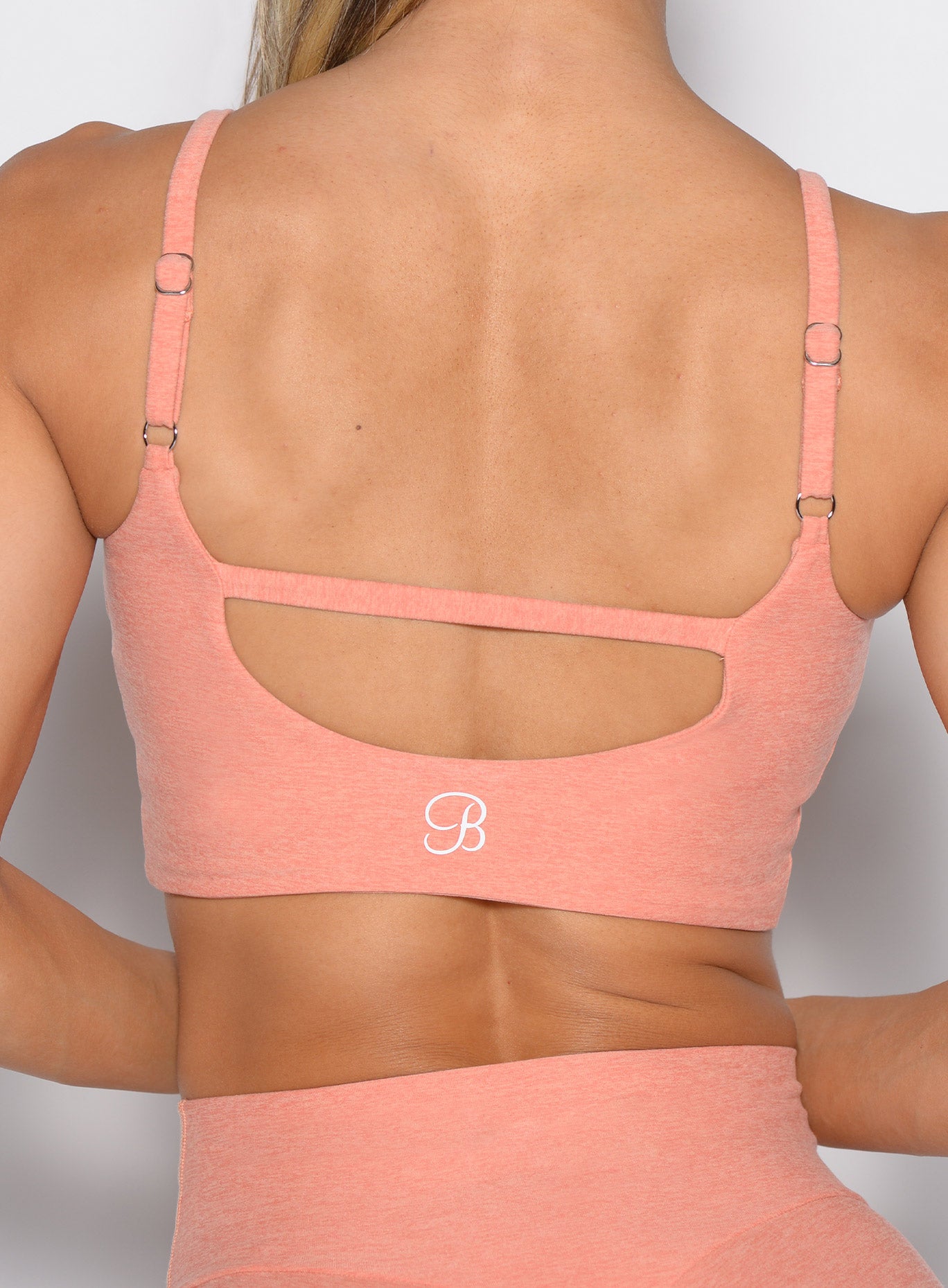 Coral Peach Loop Luxe Bra Top with a detailed back and sculpting, ruched front gym fit.