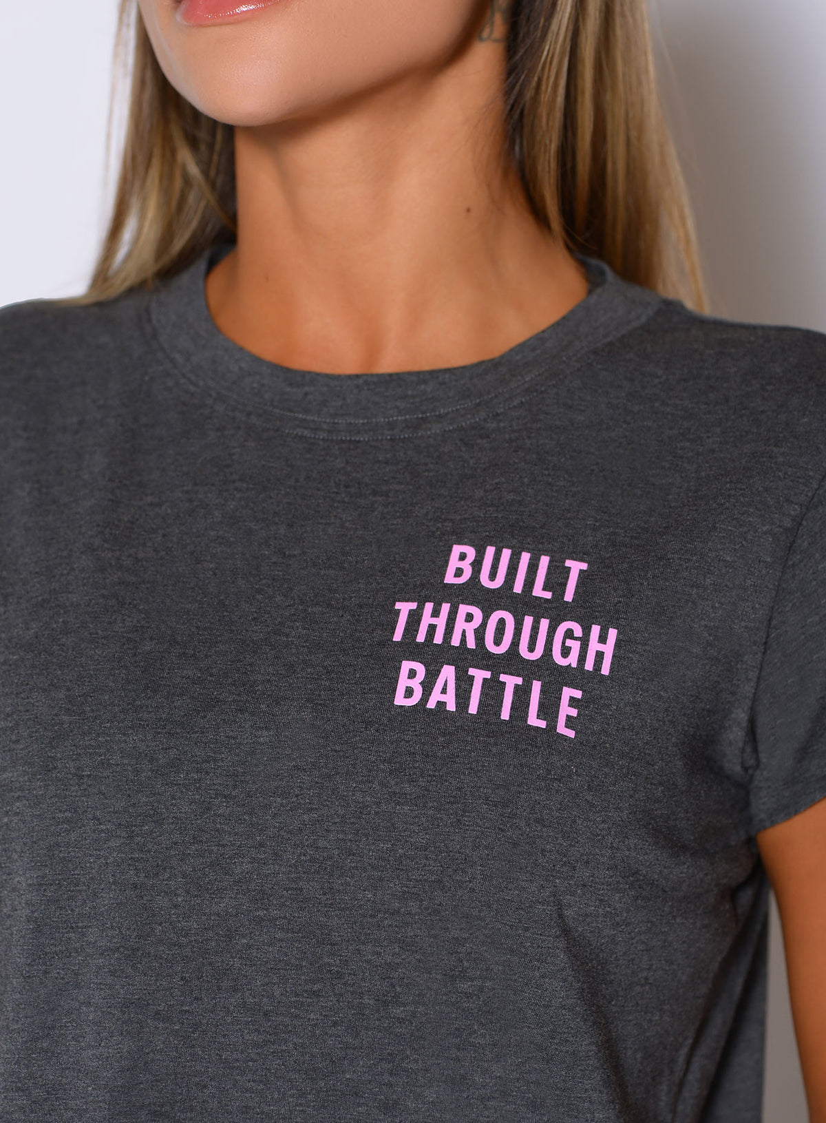 Macro detail of The Lover Fighter Tee in Charcoal showing Built Through Battle chest print.