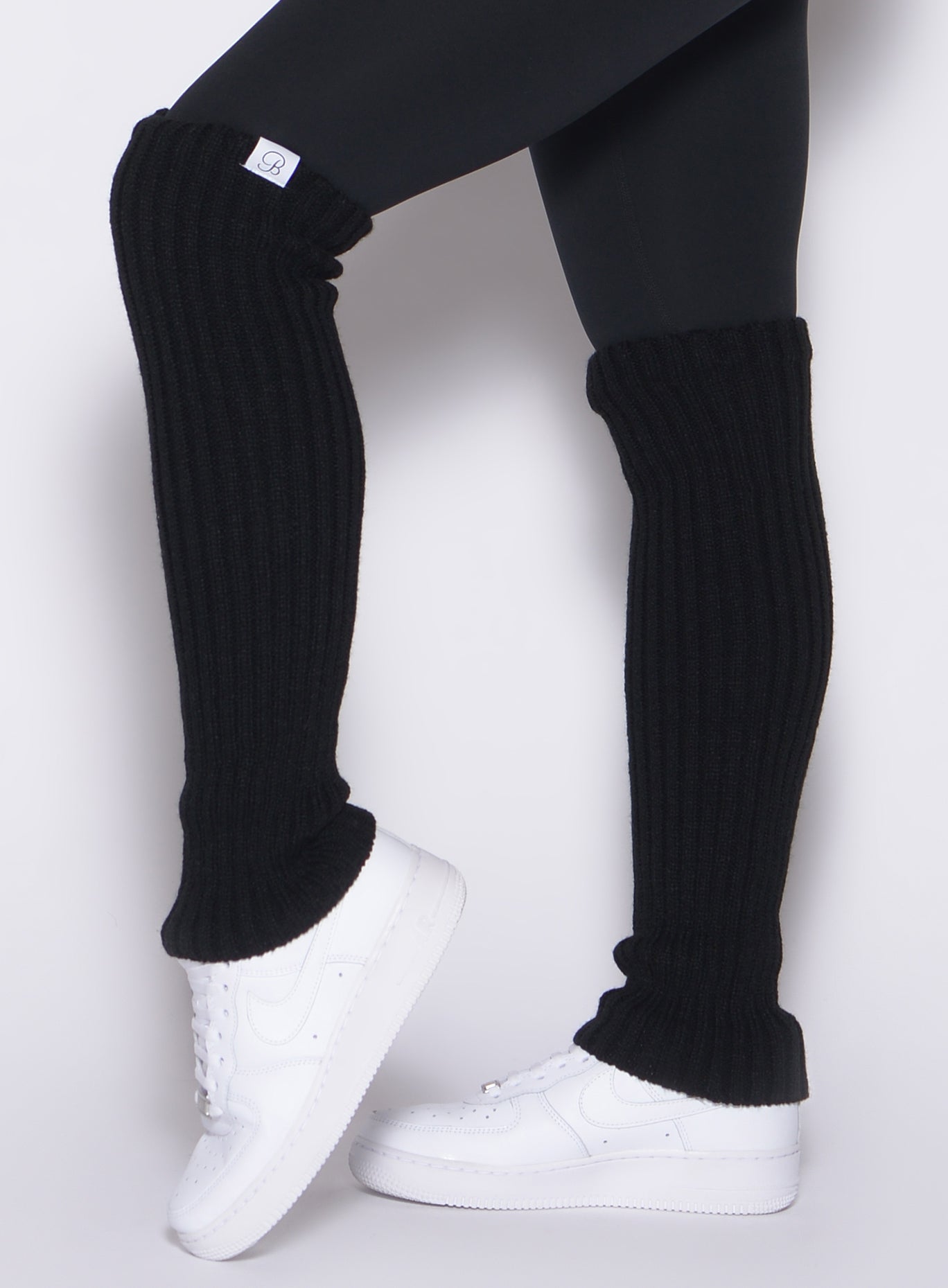 Plush black Luxe Leg Warmers with a soft rib knit and top elastic for secure layering.