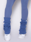 close up front view of a model wearing the Luxe Leg Warmers in blue chill color