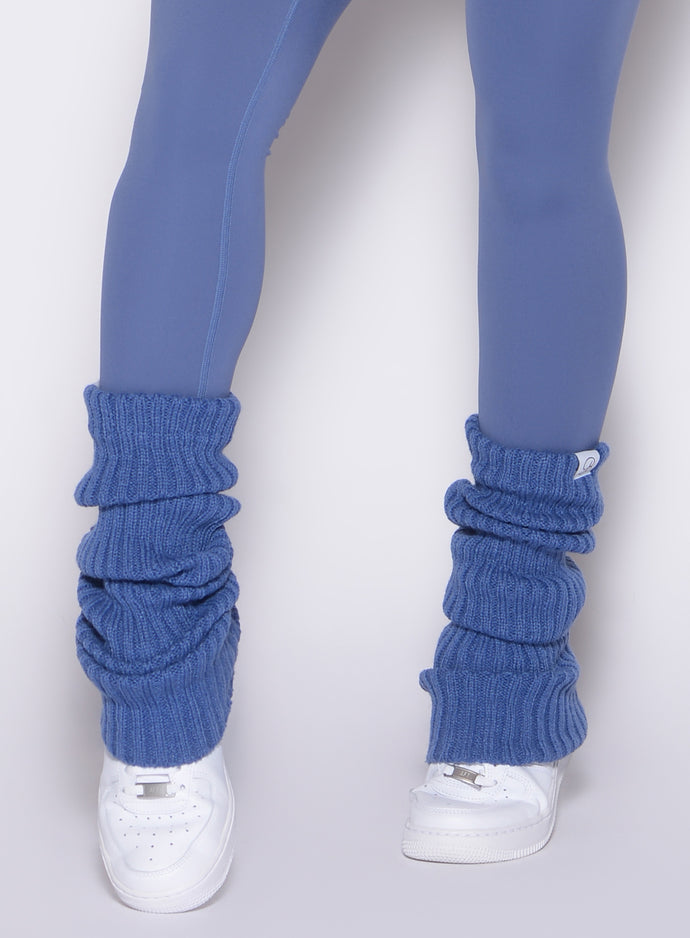 close up front view of a model wearing the Luxe Leg Warmers in blue chill color