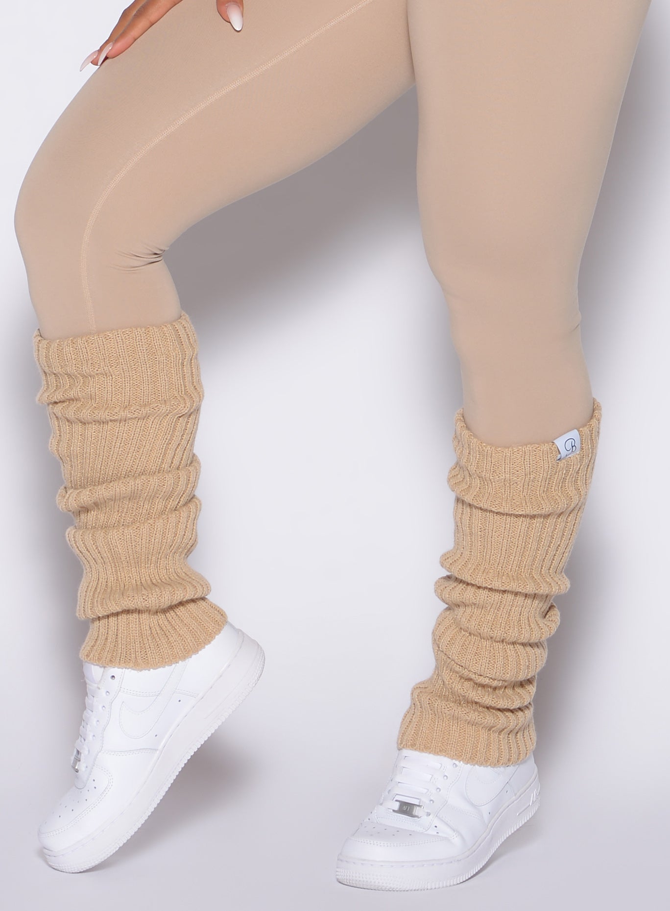 left side close up shot of a model wearing the Luxe Leg Warmers in glacial beige color