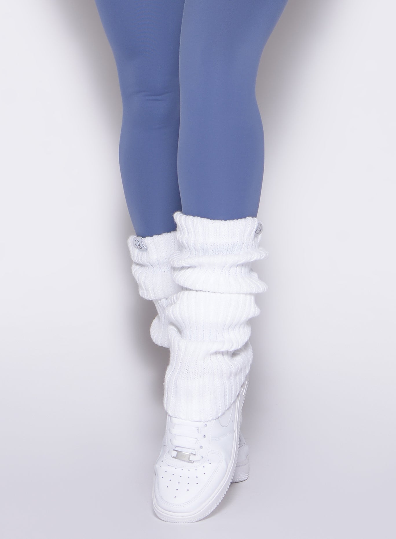 White Luxe Leg Warmers in a plush ribbed knit; cozy layering for gym or studio sessions.