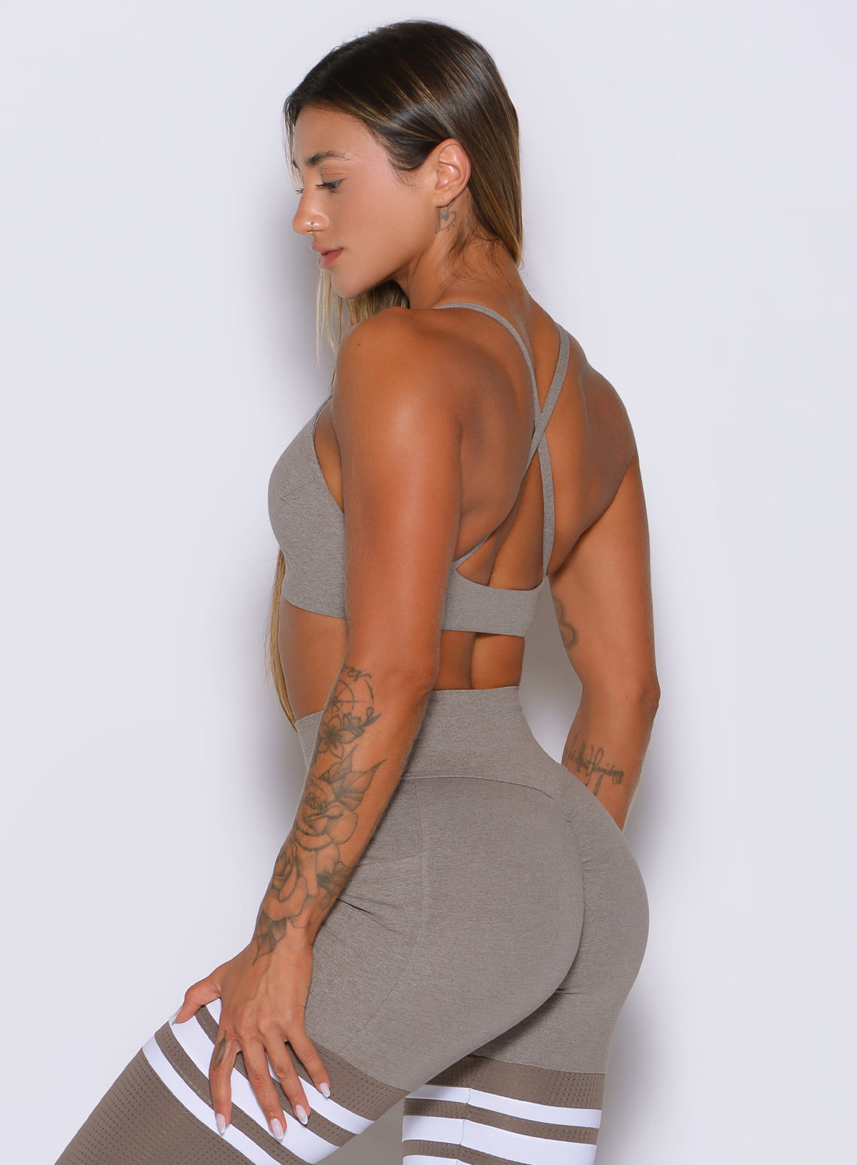 A sleek profile highlights the flexible, body-contouring fit of the Smoked Taupe ME Sports Bra