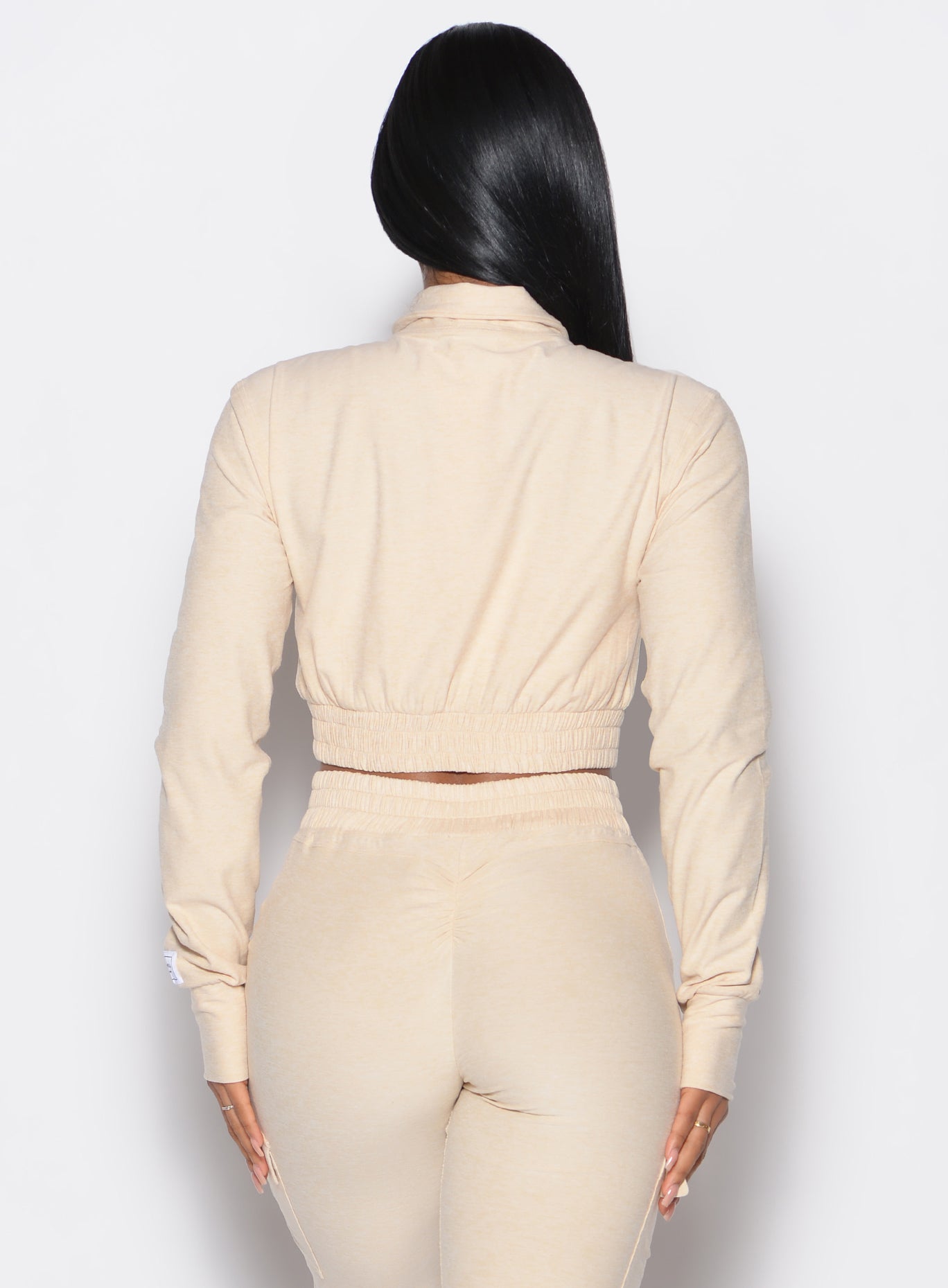 Sleek Vanilla Cloud Crop Jacket with mock high neck and back scrunch detail for elevated lounging.