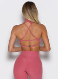 Picture of a model from the back wearing the MulTie Sports Bra in Primrose color