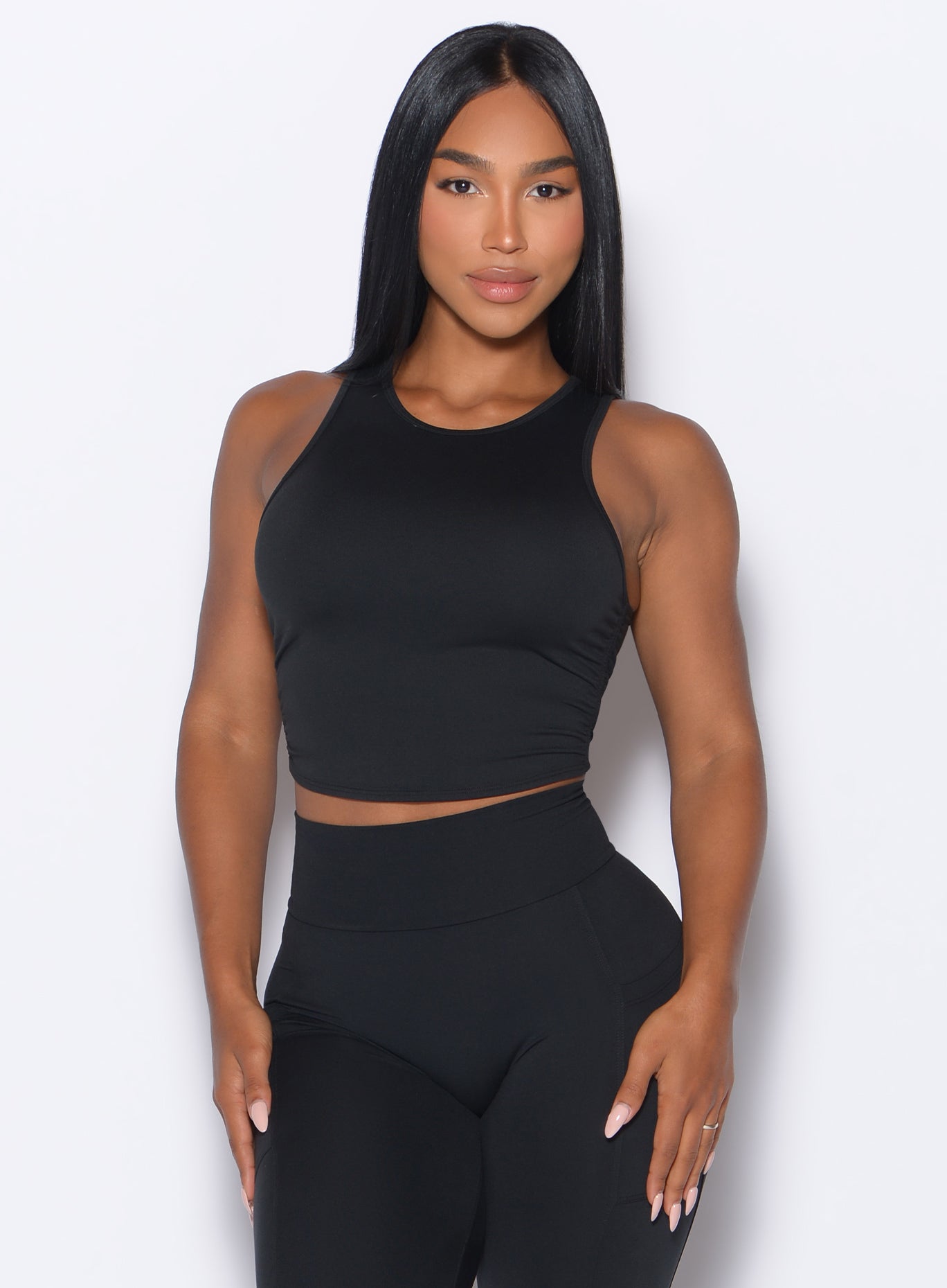 front profile view of a model posing in our Muscle Scrunch Tank in Black color