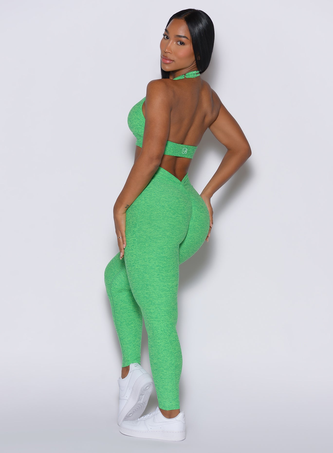 Side profile of Neon Miami Beach V Back Leggings with a sculpting scrunch seam for the gym.