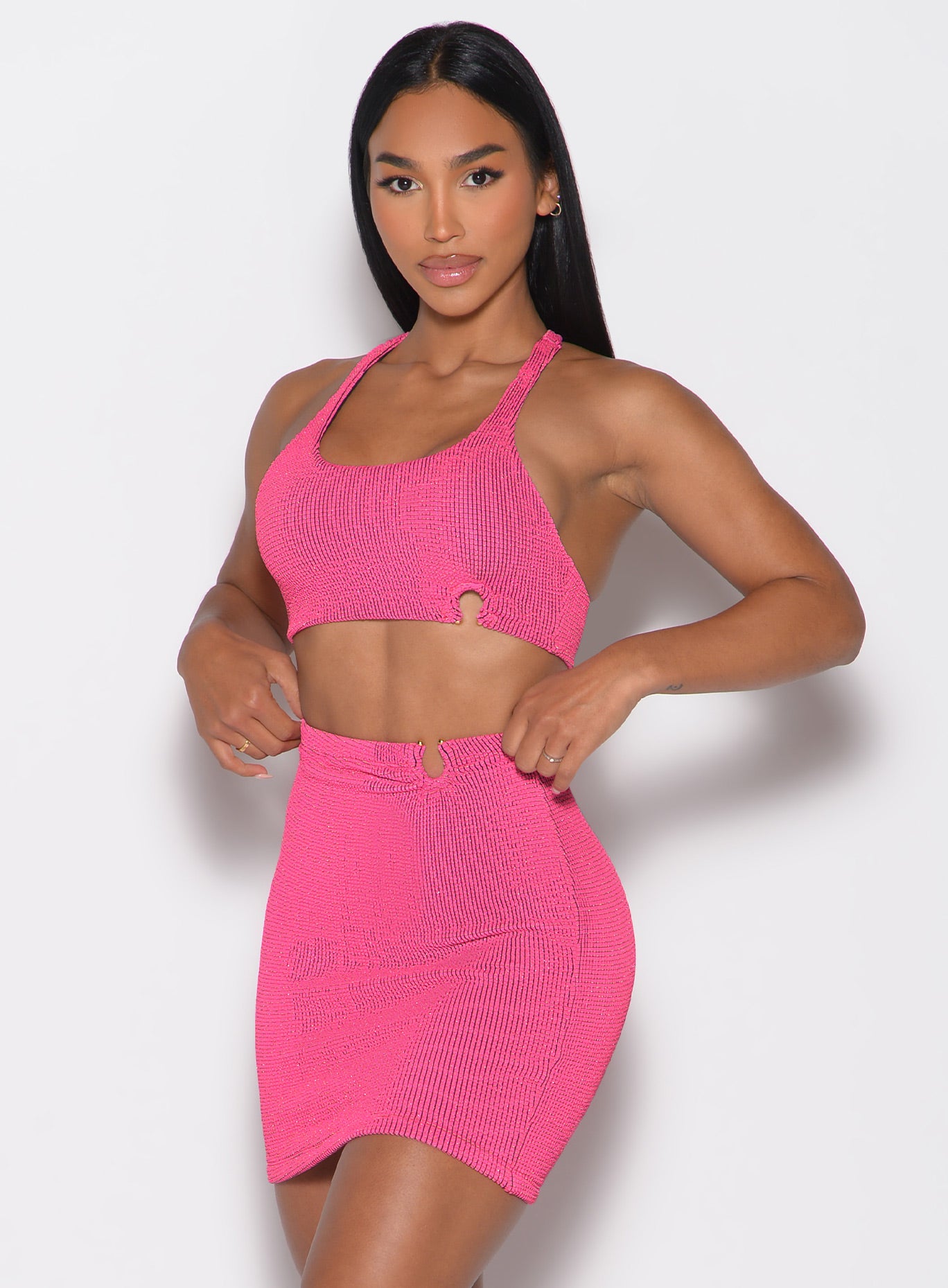front left side profile view of a model wearing the Neon Nights Bikini Top in Pink Passion color