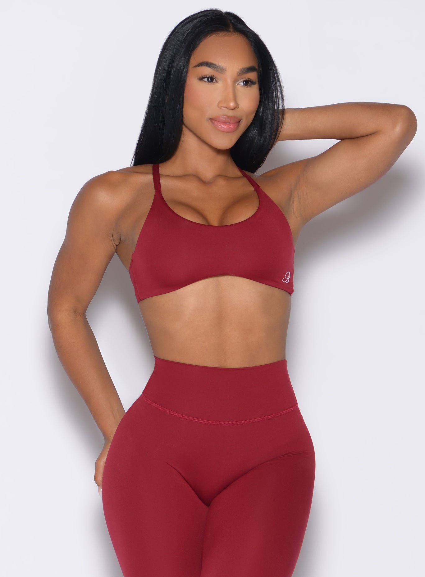 front profile view of a model looking to the left wearing the Passion Sports Bra in red velvet color