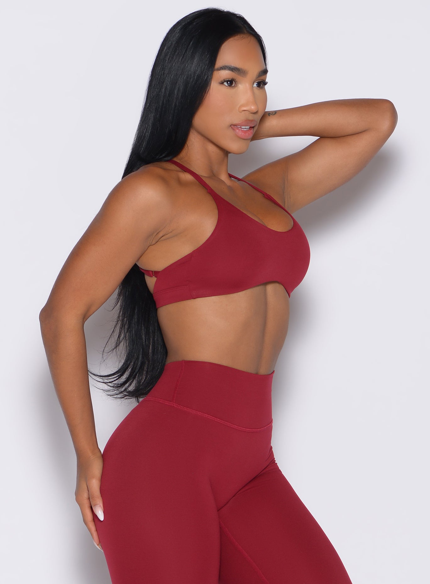 front right side profile view of a model wearing the Passion Sports Bra in red velvet color
