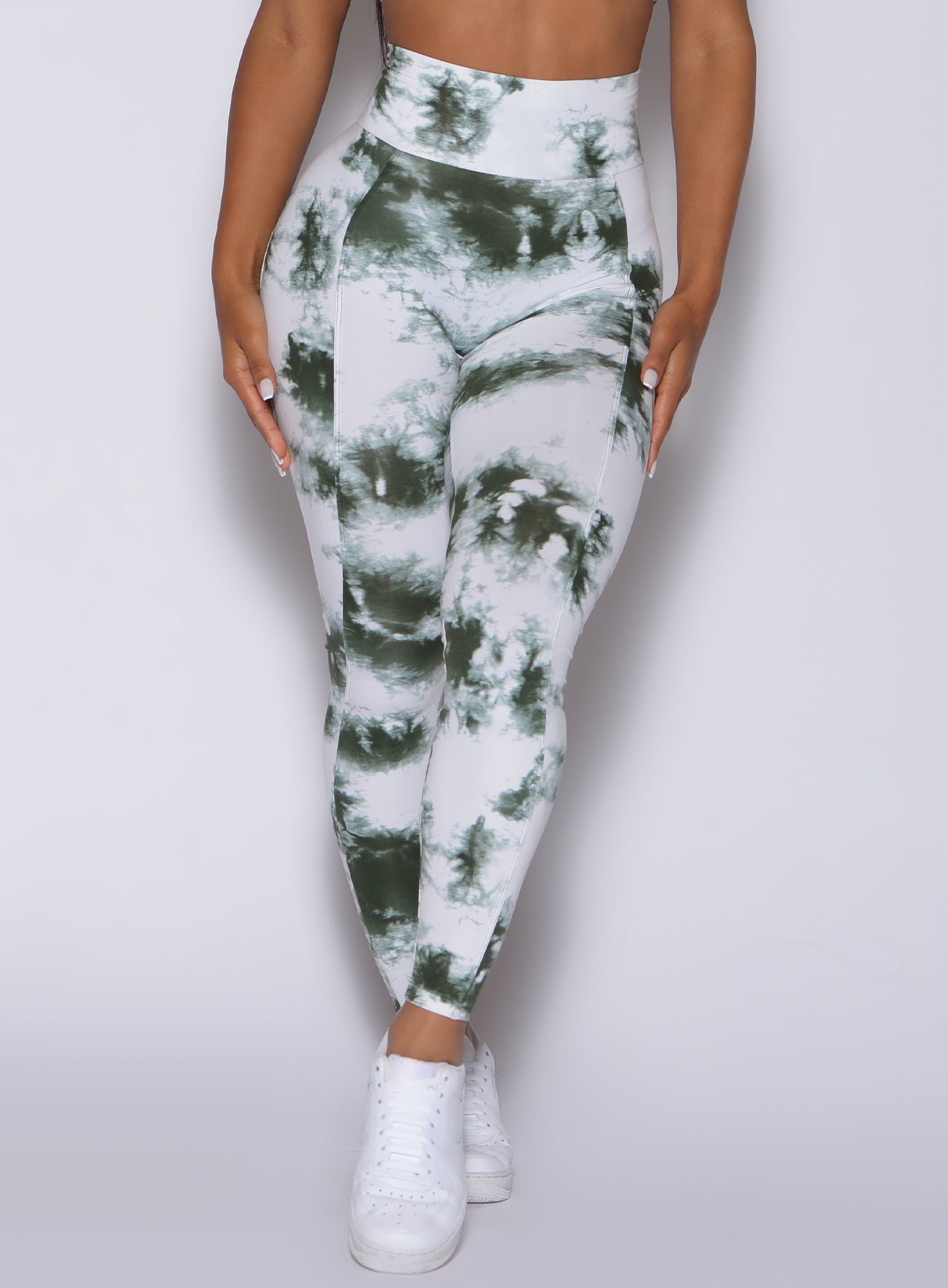 Zoomed in front view of our tie dye peach booty leggings in white green