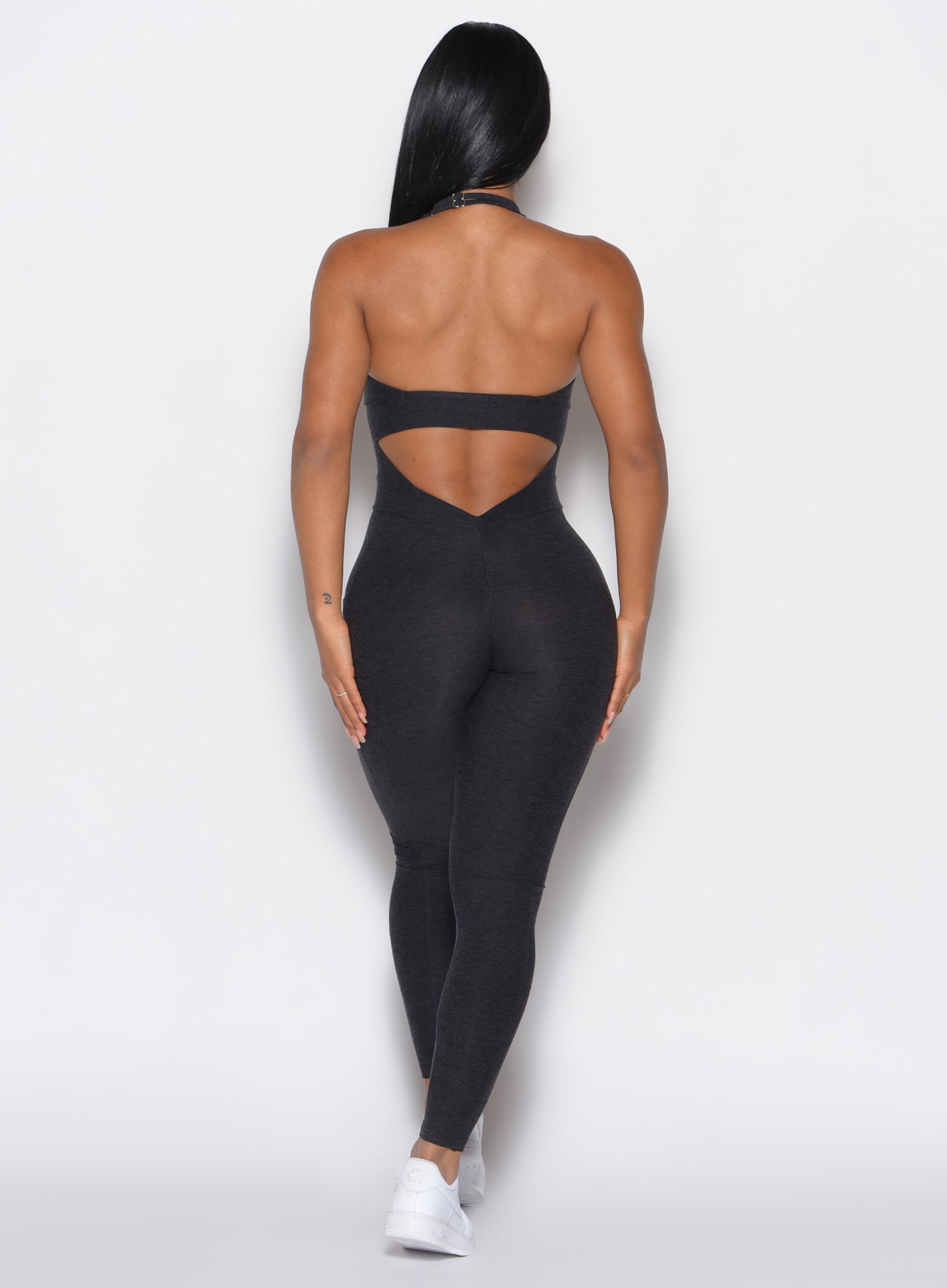 Onyx Backless Pocket Bodysuit featuring a deep V-back and side pockets for a sculpted gym fit.