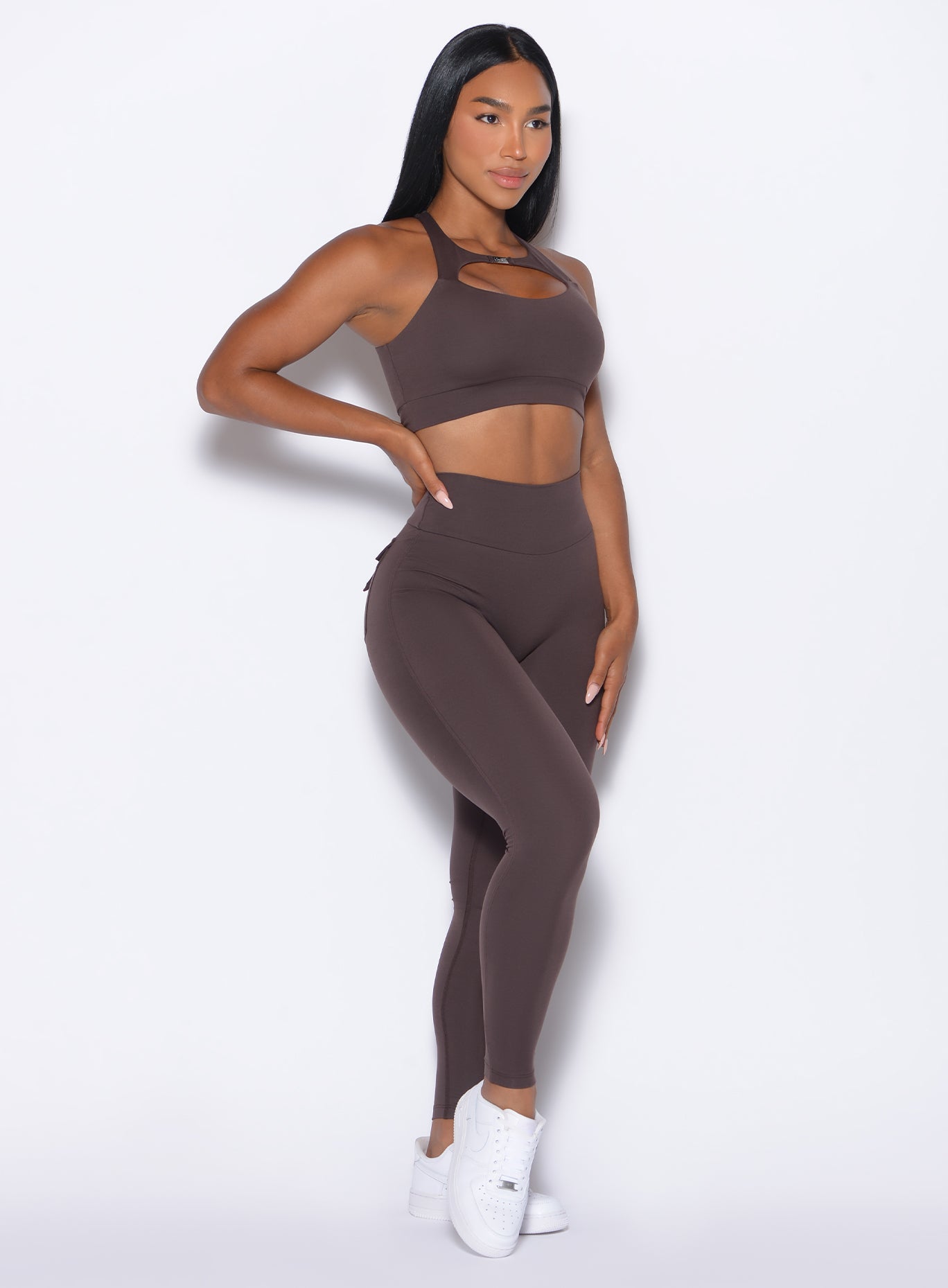 front profile picture of a model in our Pocket Pop Leggings 2.0 in Seal Brown color and the matching bra