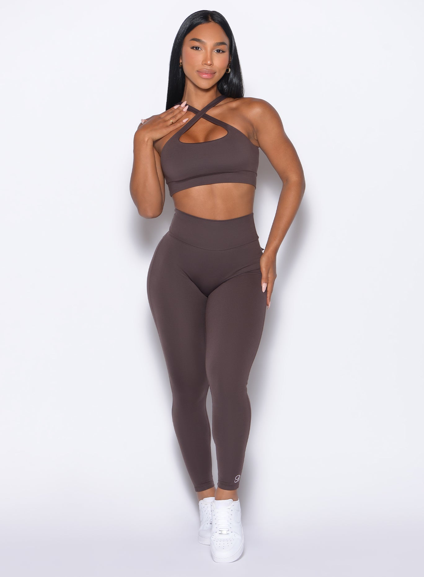 front profile view of a model wearing our Pocket Pop Leggings 2.0 in Seal Brown color and the matching bra