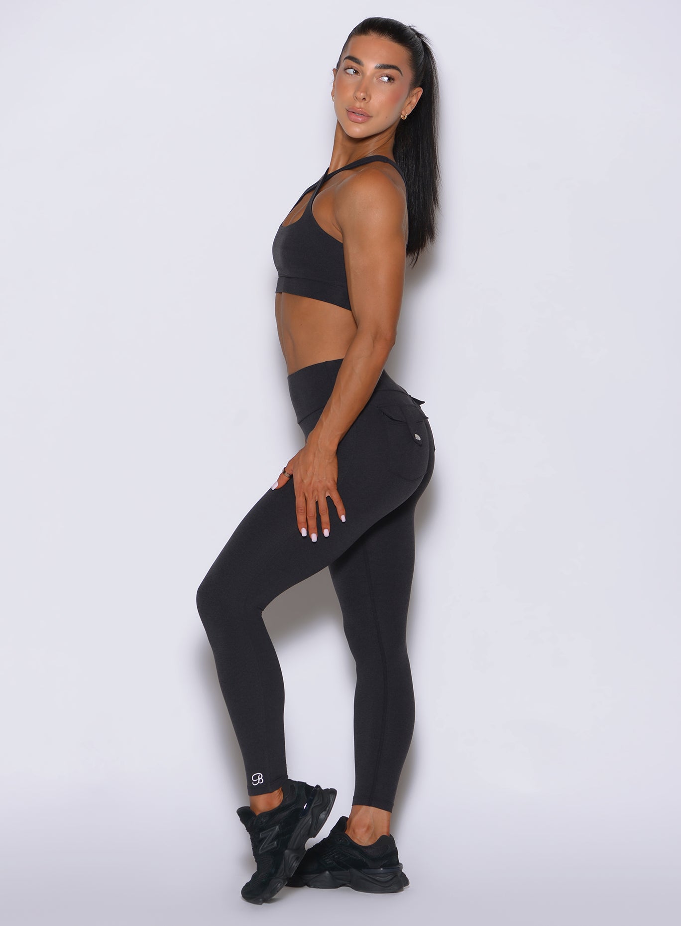 Sleek left profile of the high-waisted obsidian black leggings, highlighting the smooth leg line