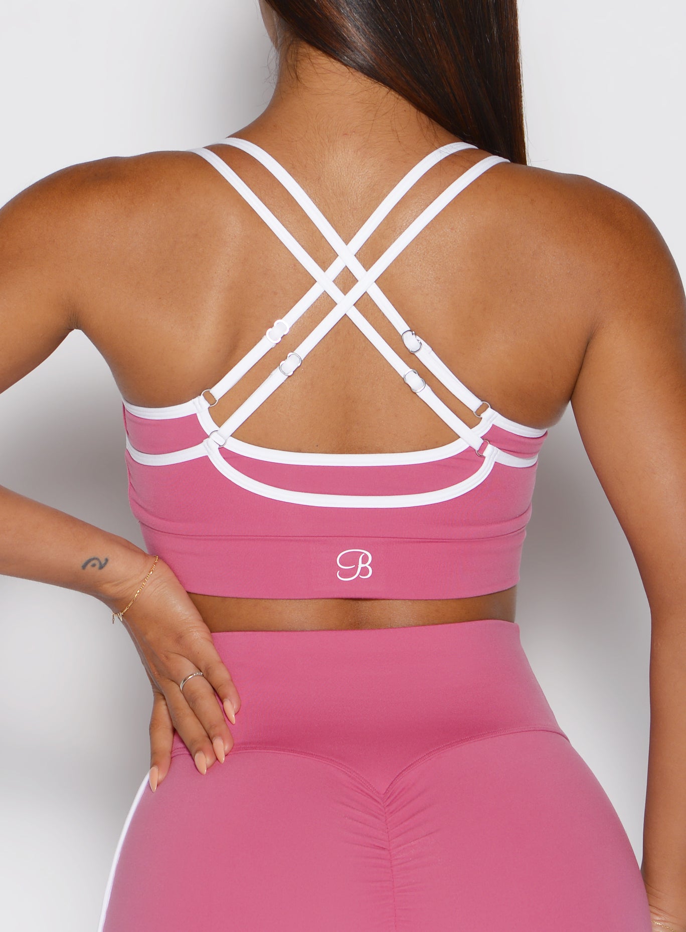 Close-up back view of the Empowered Pink Power Line Bra featuring a supportive, strappy design.