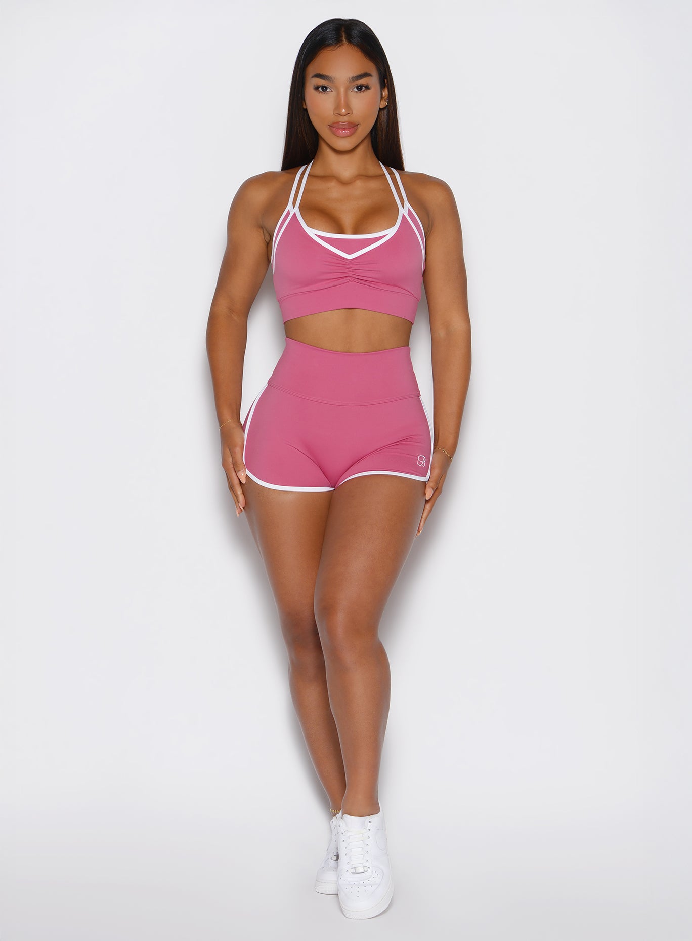 front profile view of a model wearing the Power line shorts in empowered pink color