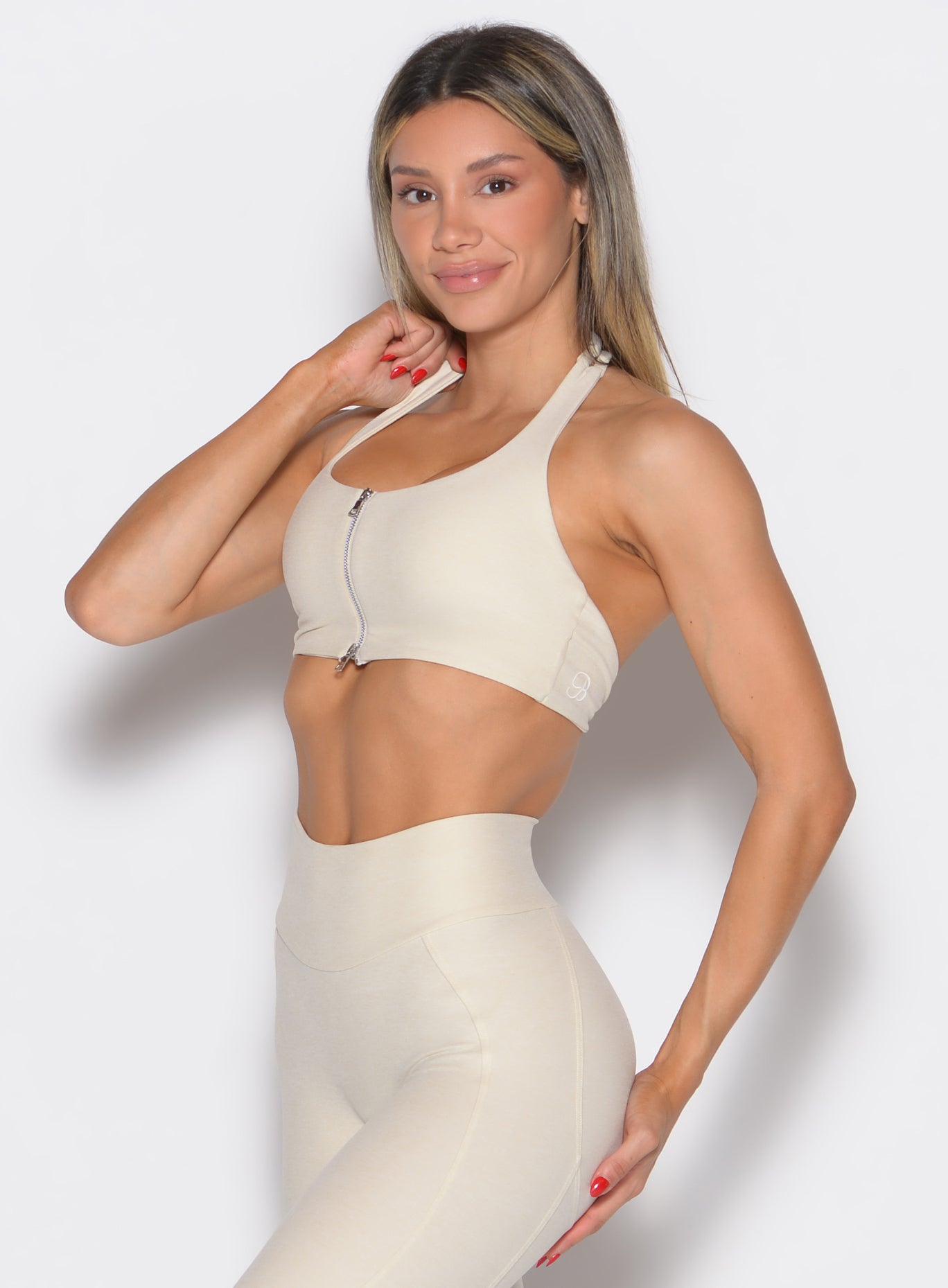 front left side profile view of a model wearing the Power Zip Tank bra in pearl white color