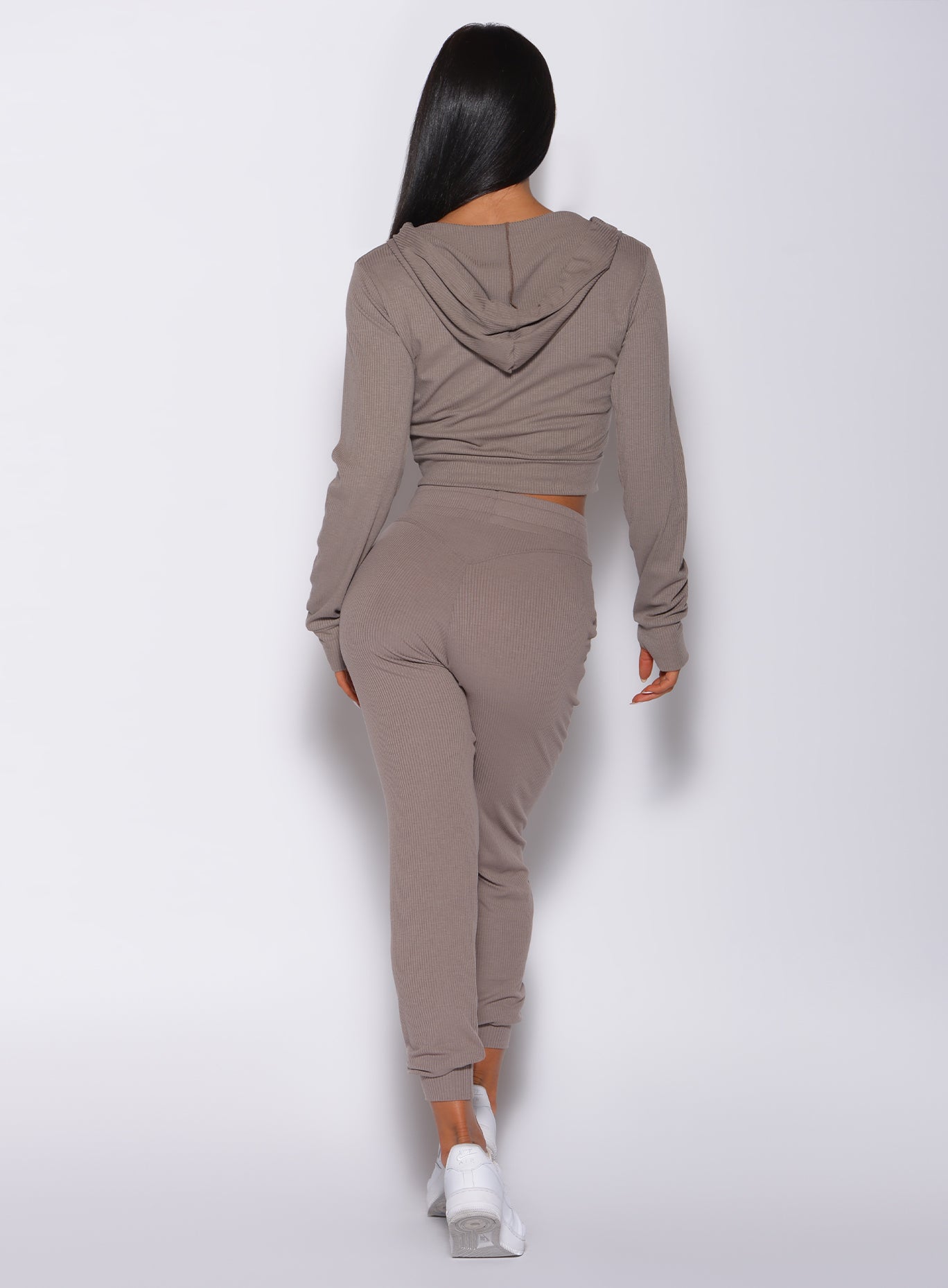 back profile view of a model in our comfort rib joggers in navy and a matching bra