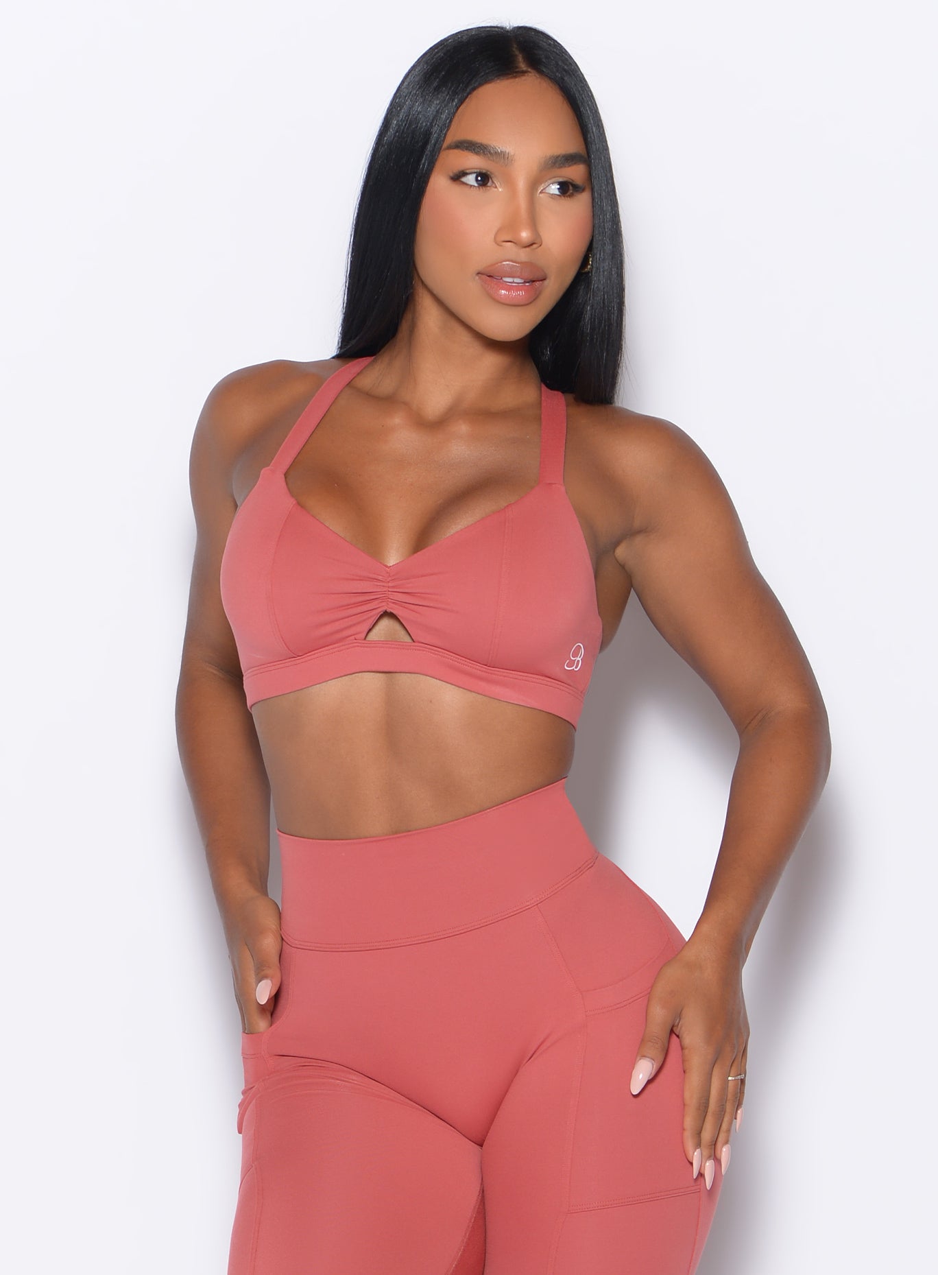 front profile view of our model looking to the left wearing the Sweetheart Sports Bra in Terracotta color