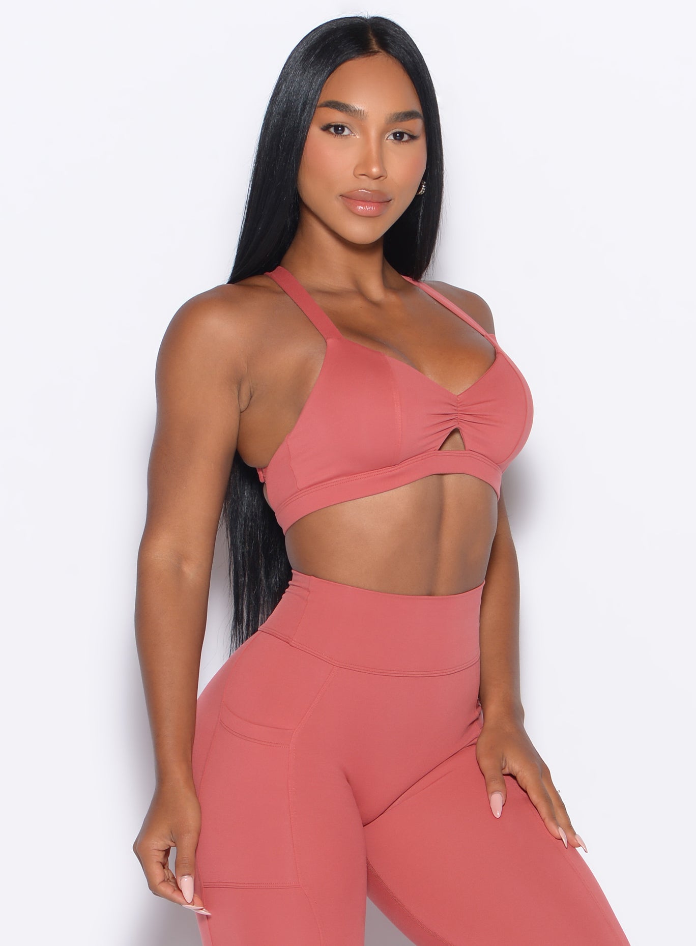 Front right side profile view of our model wearing the Sweetheart Sports Bra in Terracotta color