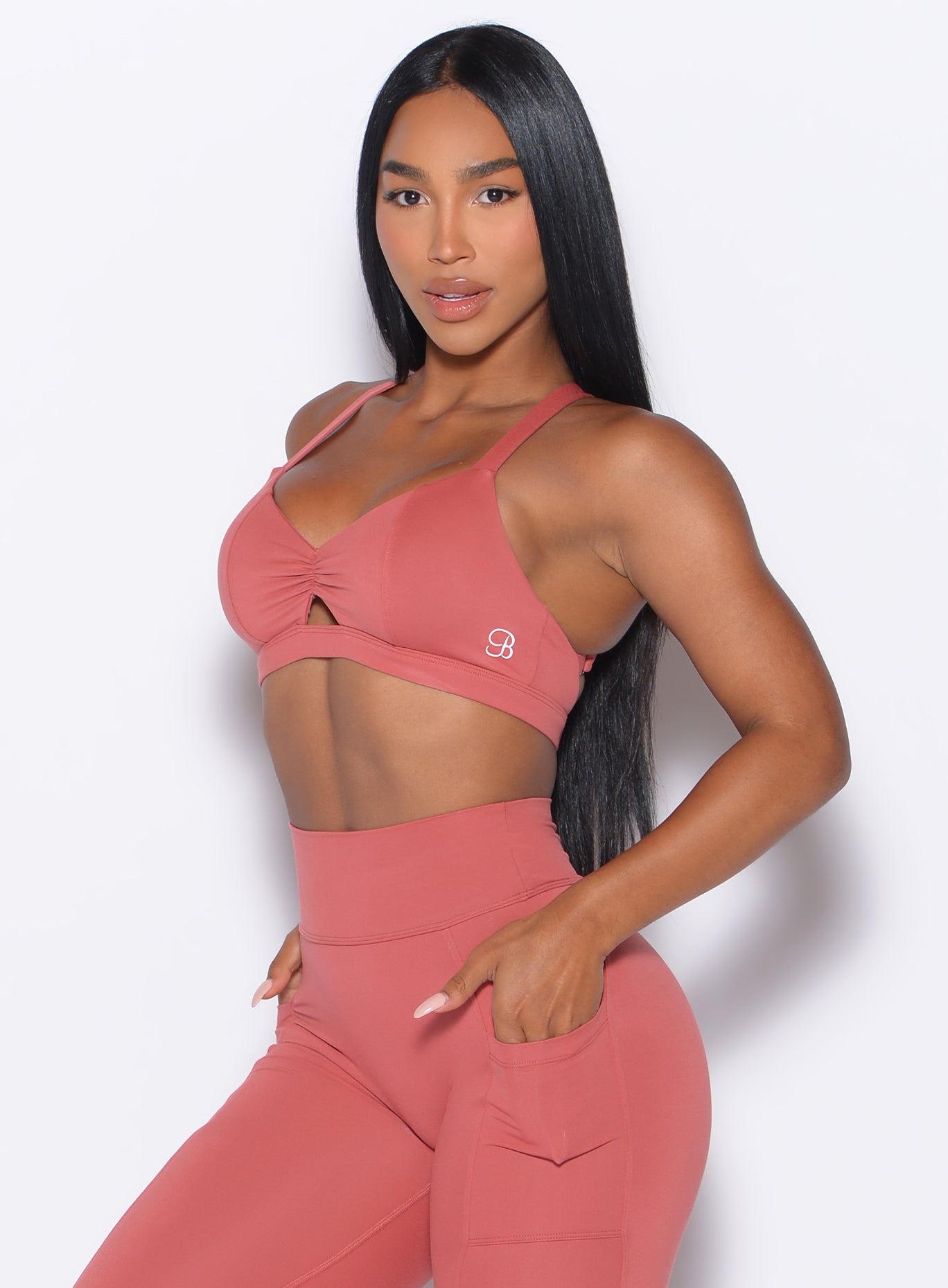 front left profile view of our model wearing the Sweetheart Sports Bra in Terracotta color