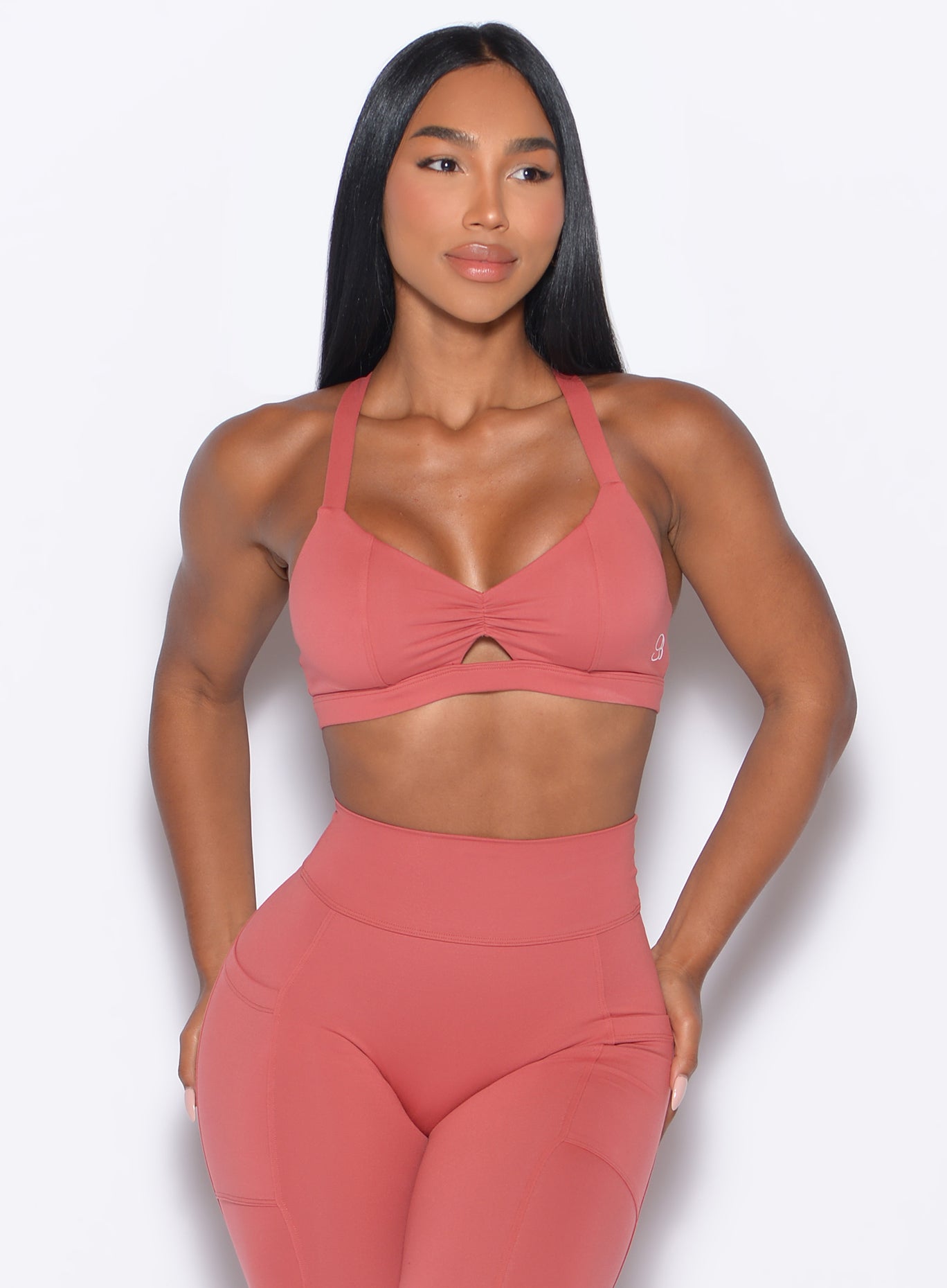 Front profile view of our model wearing the Sweetheart Sports Bra in Terracotta color paired with the matching leggings