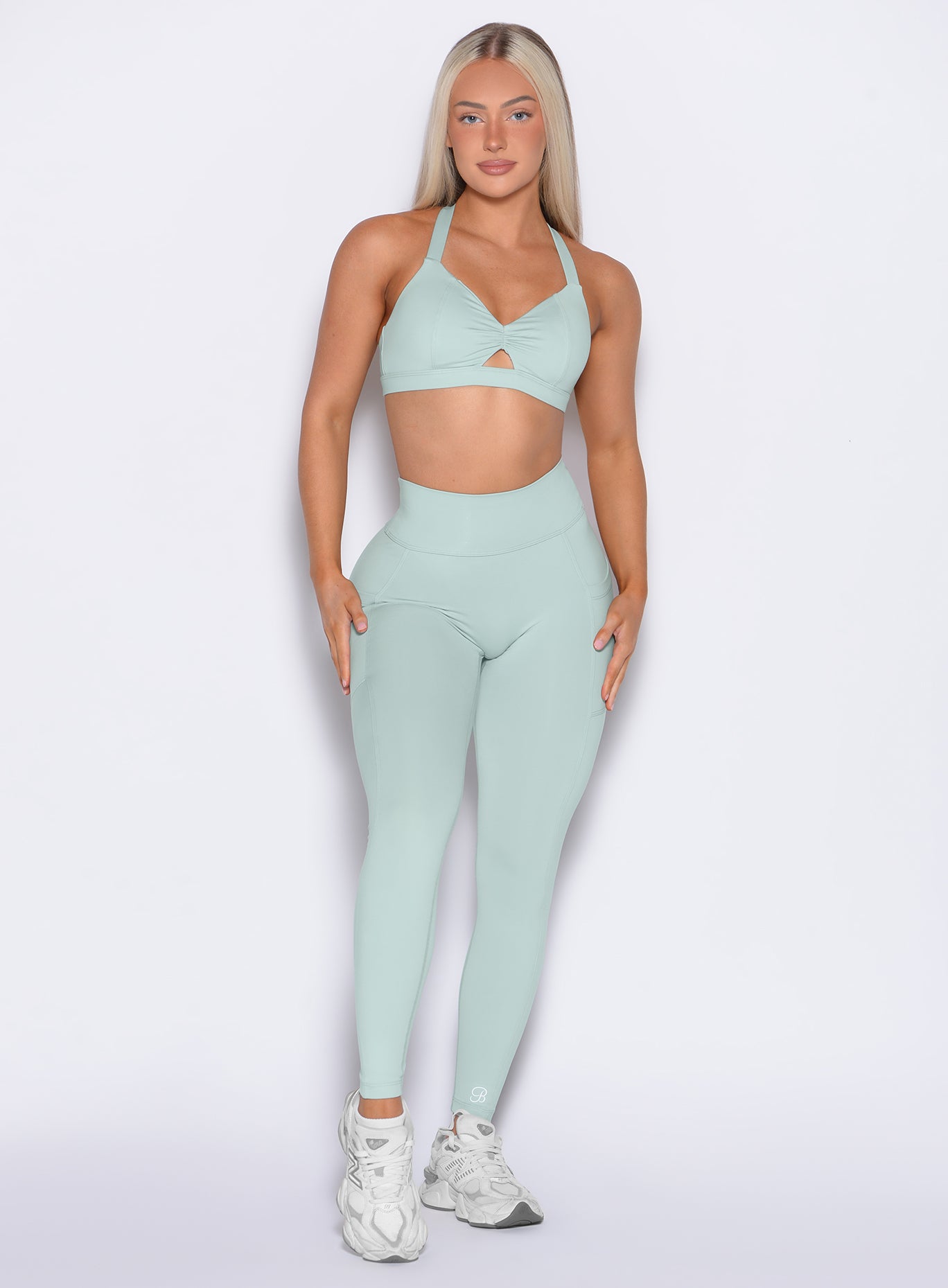 Front profile shot of our model wearing the Define Leggings in Mist color paired with the matching bra