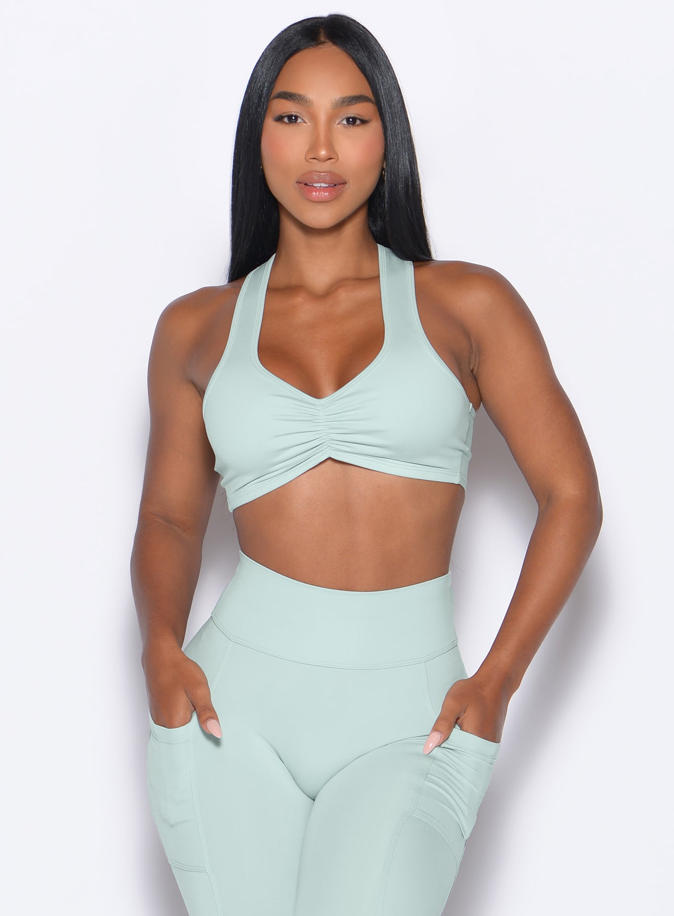 Mist Scrunch Tank Bra with high-waisted pocket leggings for a cohesive, sculpting yoga set.
