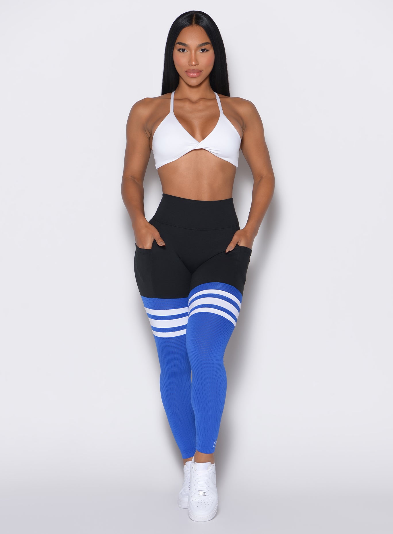 Front  profile view of a model wearing our Scrunch Thigh Highs in Black and Sky color along with a white bra