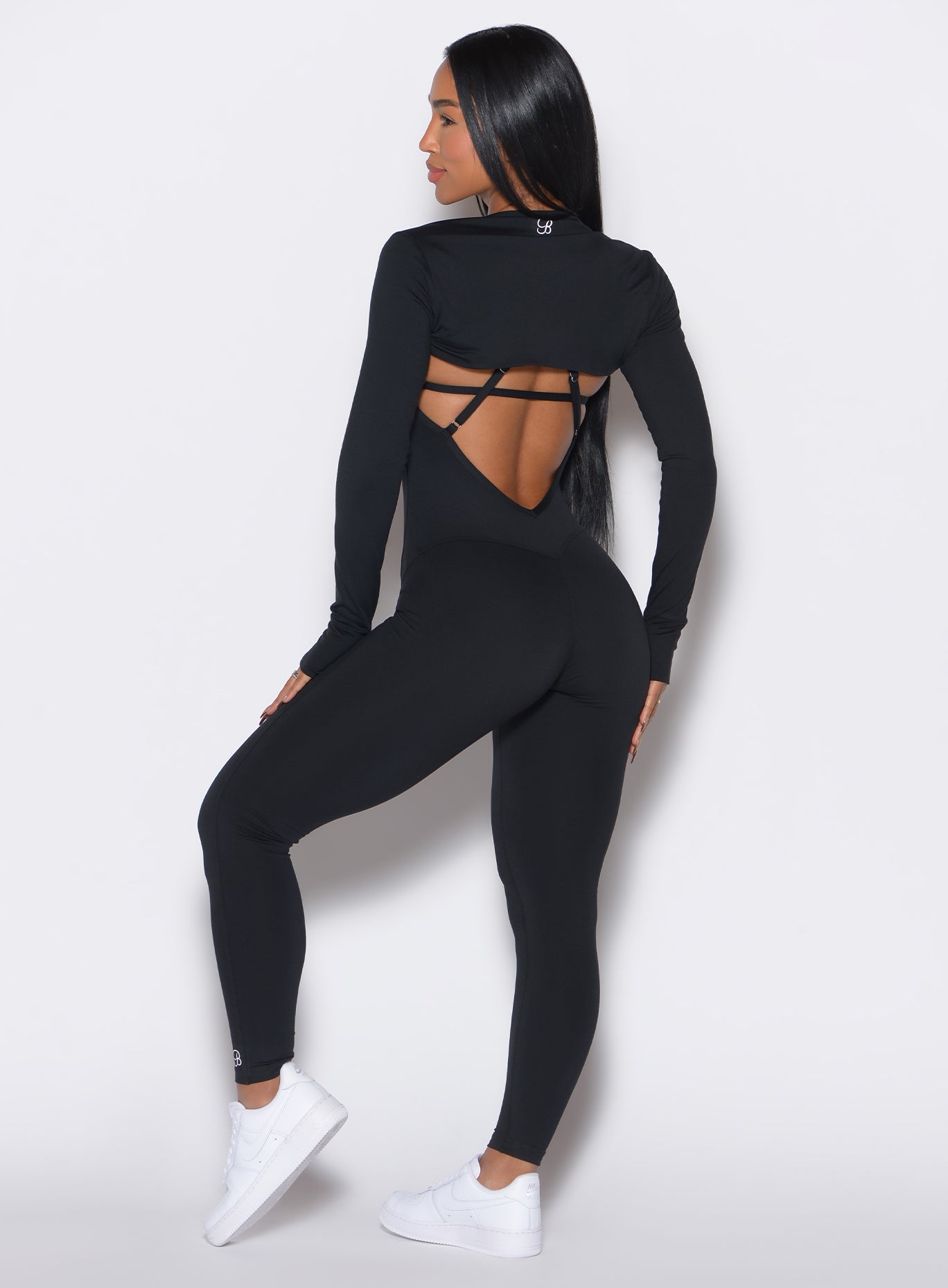 Black Shape Shrug featuring long sleeves and functional thumbholes for a sleek gym layering.